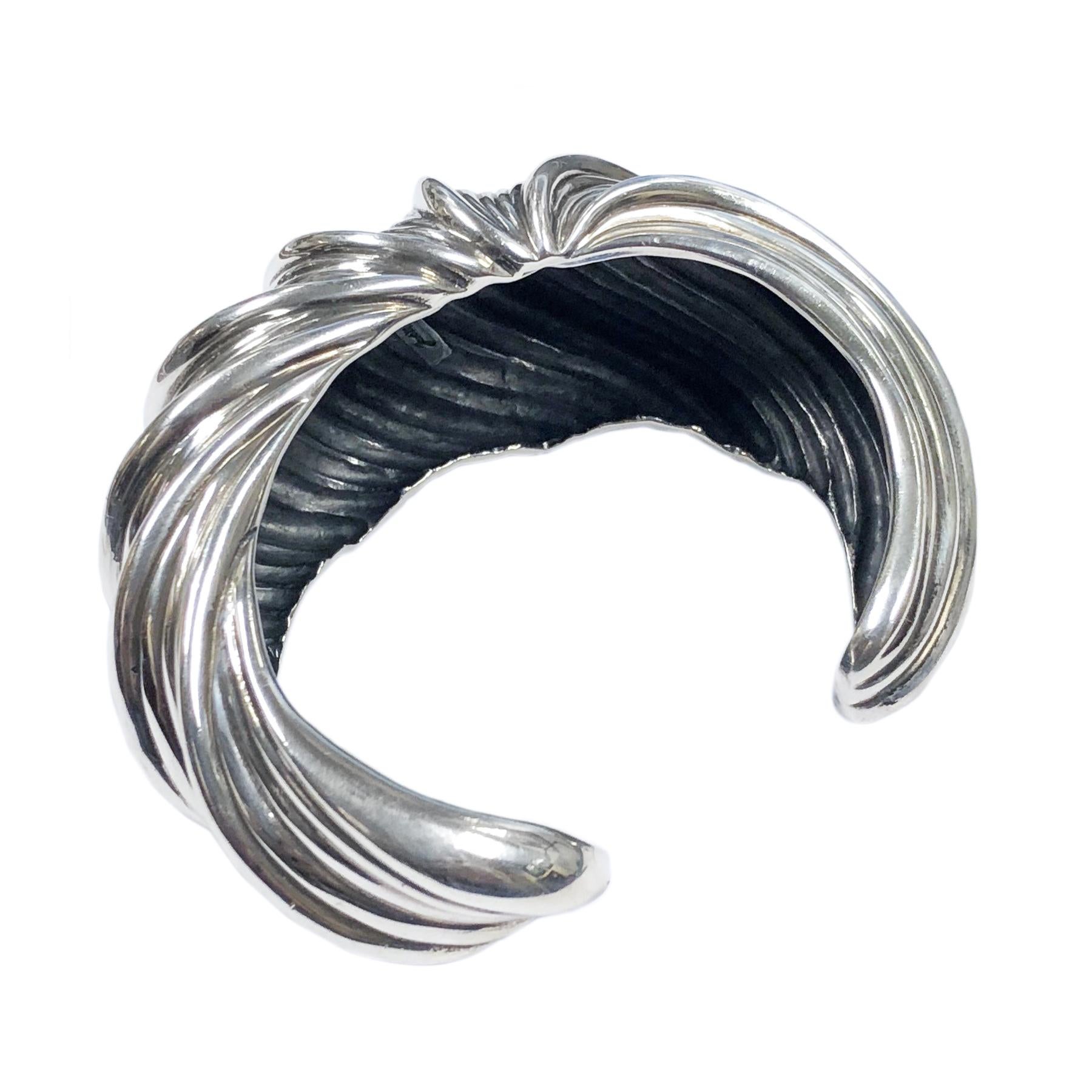 Circa 1990 Judith Leiber Sterling Silver Cuff Bracelet, Solid and Heavy and having a ribbed design and measuring 1 1/4 inch wide with a 1 inch wide opening and an inside measurement of  6 inches. 