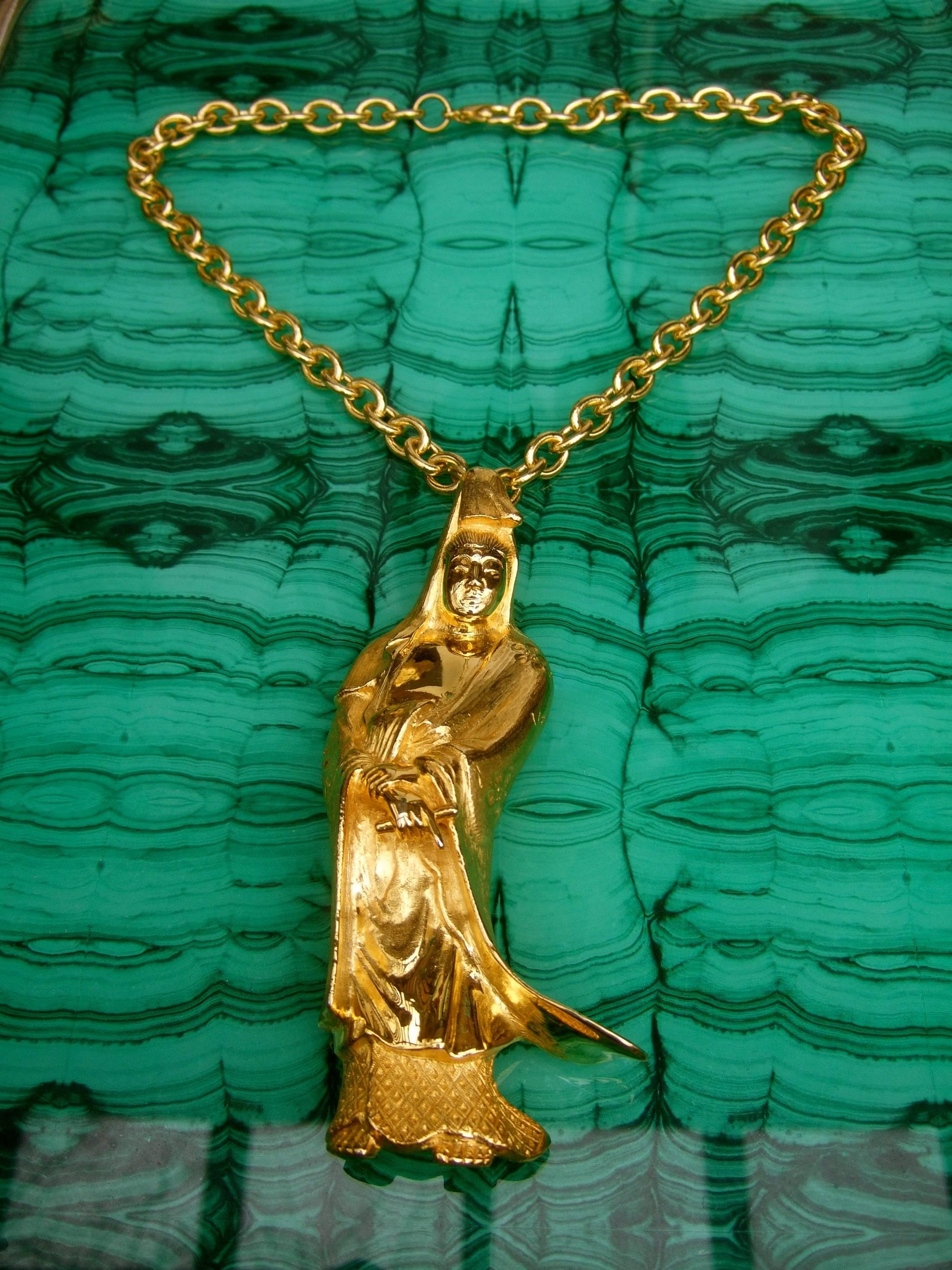 Judith Leiber Massive figural gilt metal pendant - brooch necklace c 1970s
The Asian theme pendant necklace is designed with a huge Japanese 
style immortal figure suspended from a heavy gauge gilt metal chain

The Japanese style figure can be