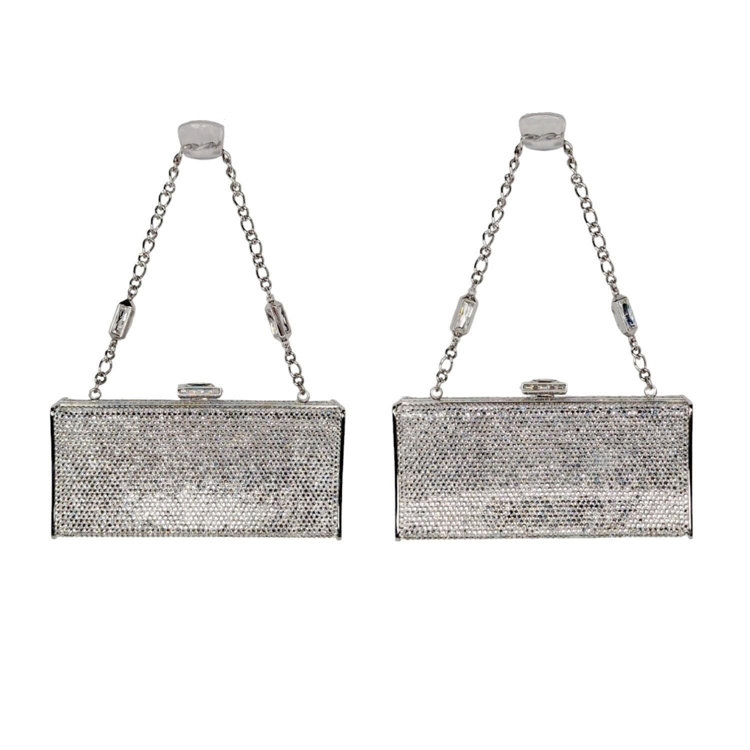 JUDITH LEIBER Swarovski Crystal Minaudiere Clutch Silver. Stunning things come in very small packages. This stunning evening clutch is entirely encrusted in crystals. The bag features a silver chain strap and a top press lock. The clutch opens to a