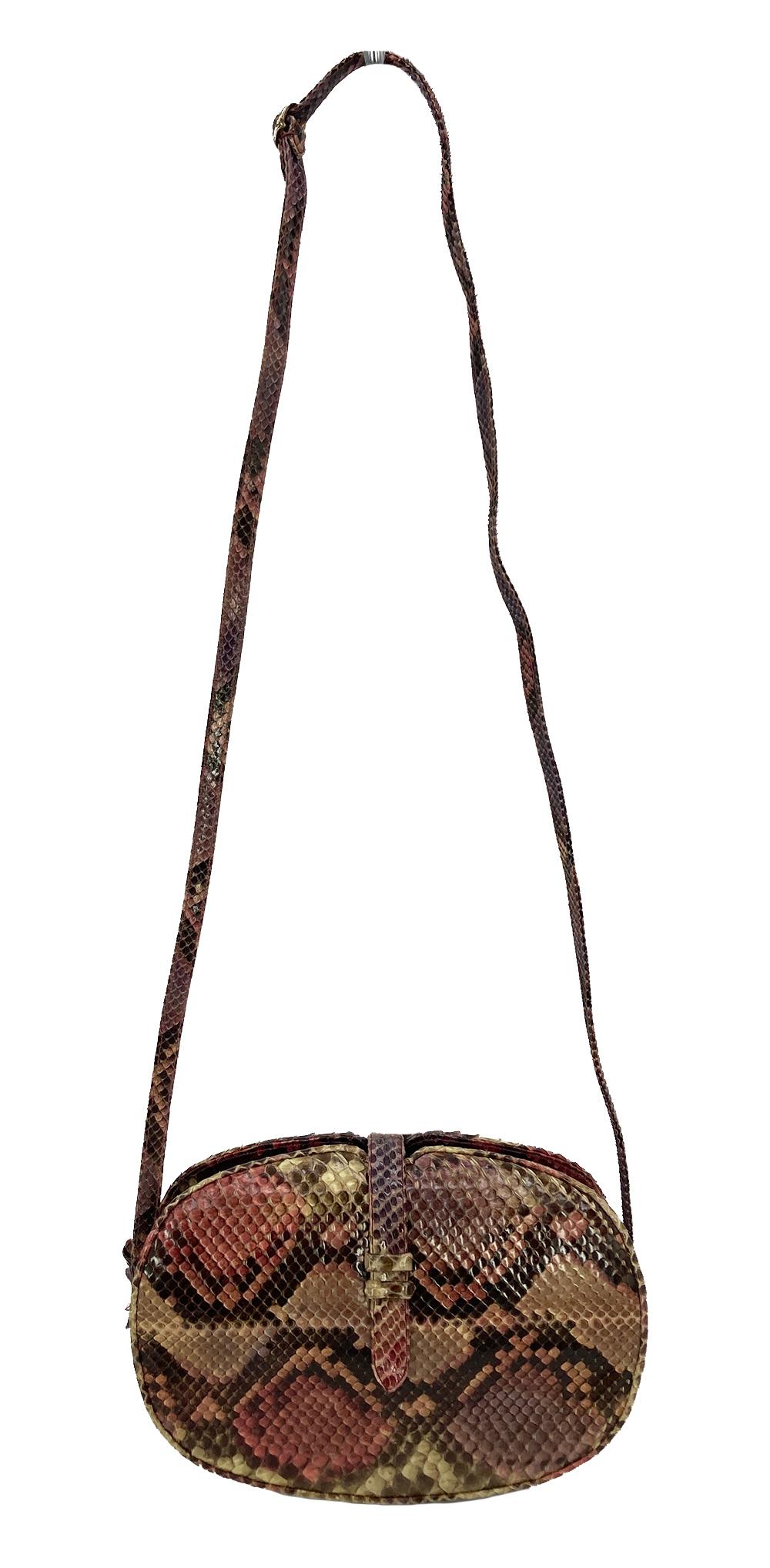 Judith Leiber Pink Python Snakeskin Shoulder Bag in very good condition. Natural python snakeskin exterior in pink tone with beige, tan, and purple subtle accents. Top centered strap belt closure opens to 2 exterior side slit pockets and a centered