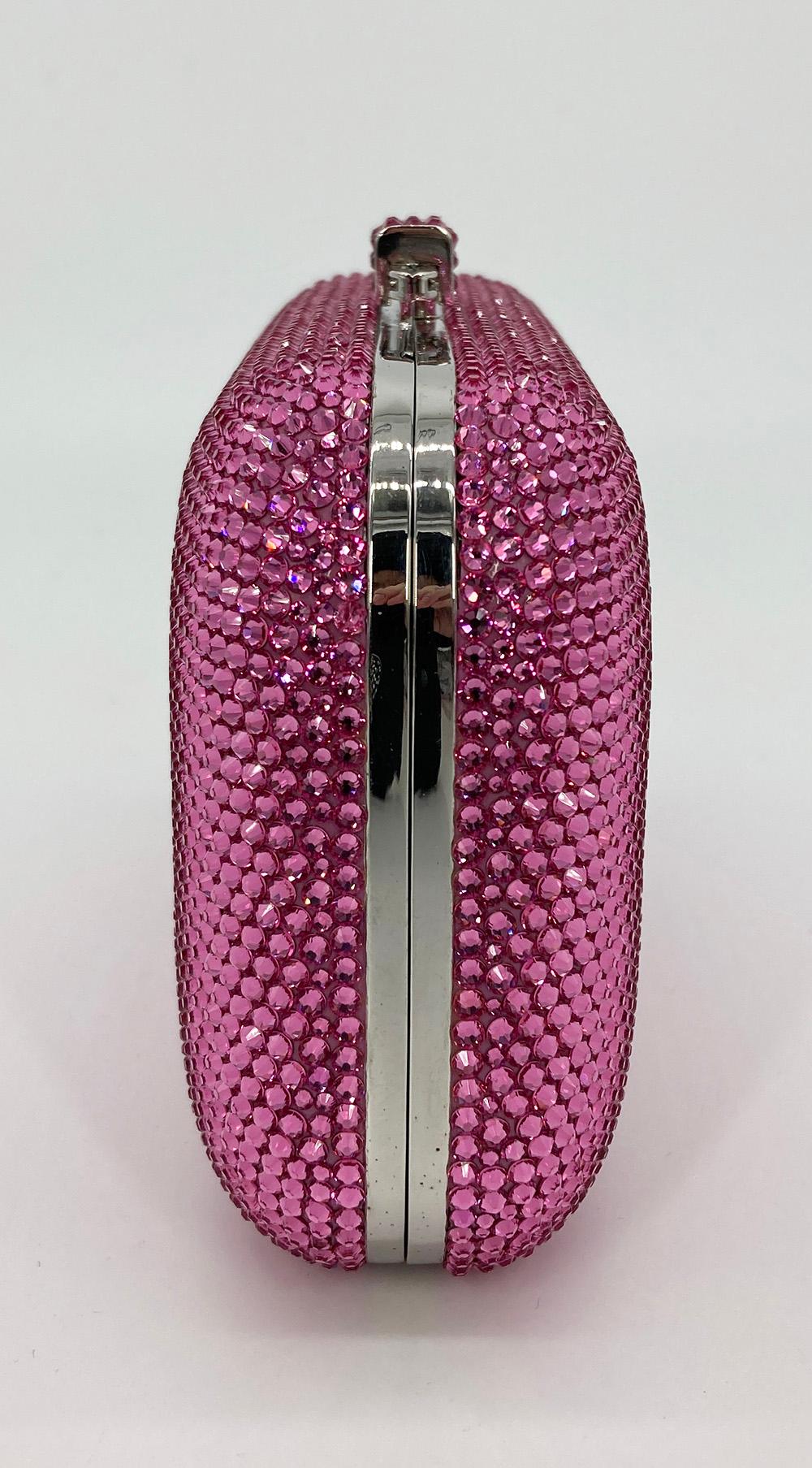 Judith Leiber Pink Swarovski Crystal Minaudiere Evening Bag in excellent condition. Pink swarovski crystal exterior trimmed with silver hardware. Top slide latch closure opens to a silver leather interior with removable silver chain handle. Overall