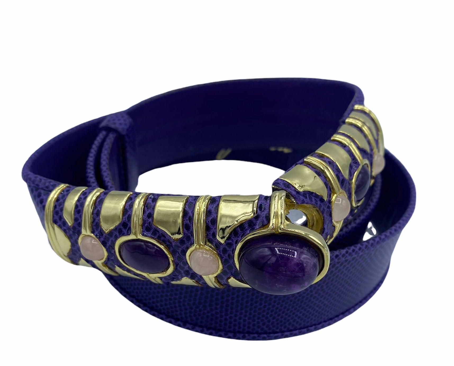 If a statement piece is what you're looking for, look no further! This is the perfect belt for style icons and superheroes alike. 

From the brilliant minds at Judith Leiber comes this eclectic Purple Lizard Belt with Opal stones and a Gold Hardware