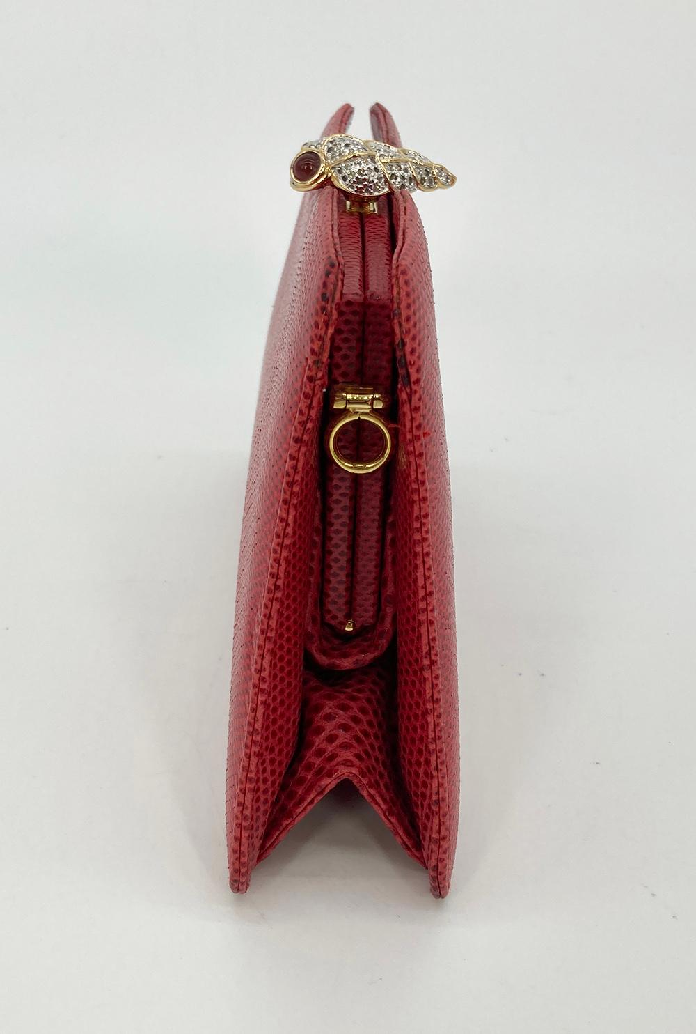 Judith Leiber Red Lizard Crystal Shell Top Clutch in excellent condition. Red lizard leather exterior trimmed with gold hardware and swarovski crystal embellished shell top closure. Push button closure opens to a red satin interior with one slit