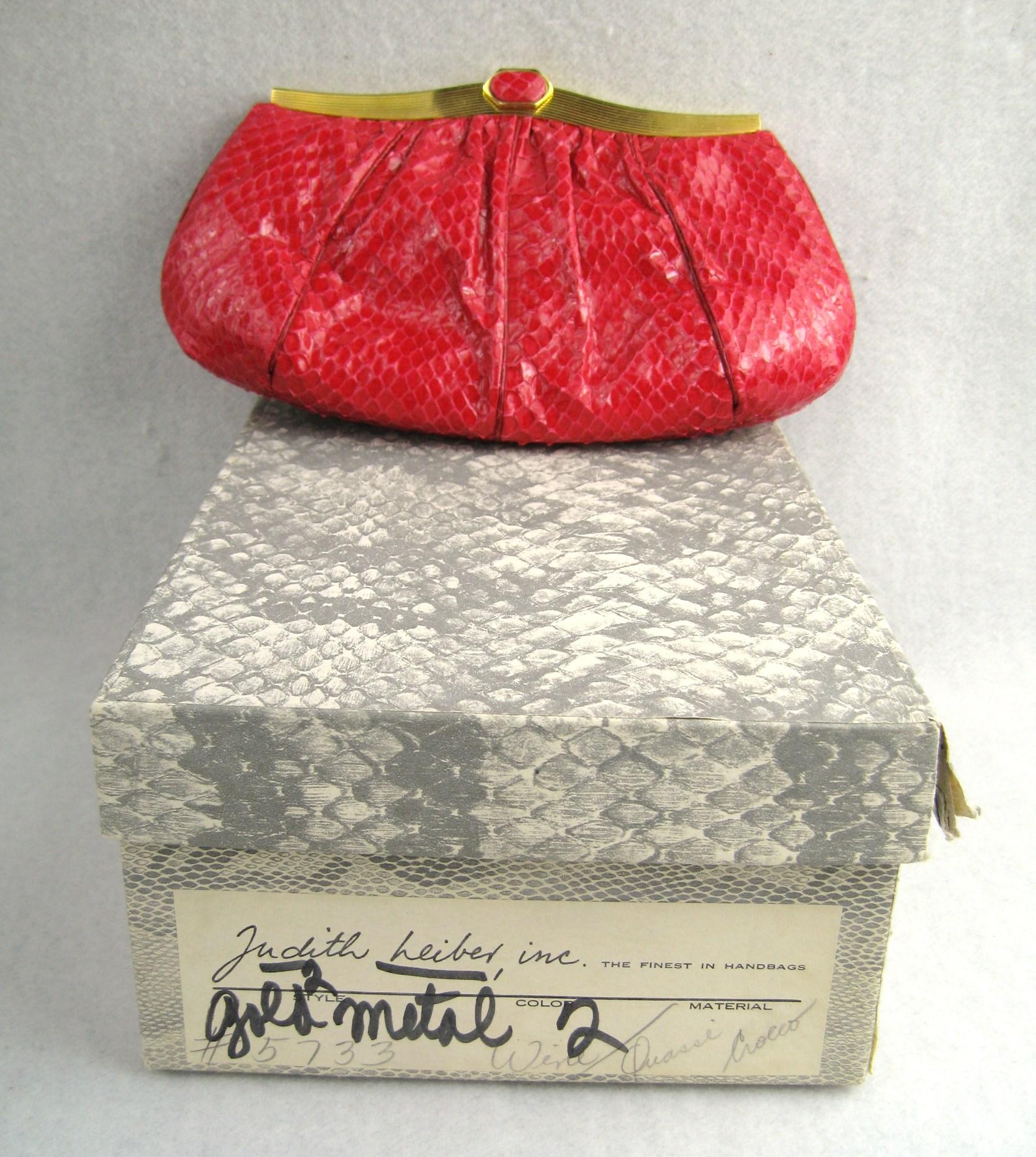 Lovely petite red 1980's snakeskin clutch shoulder bag by JUDITH LEIBER! Wonderful supple skins with shiny gold-tone frame and snakeskin flip-top clasp. Shoulder chain strap folds into the bag for clutch carrying. The interior is lovely and has  1