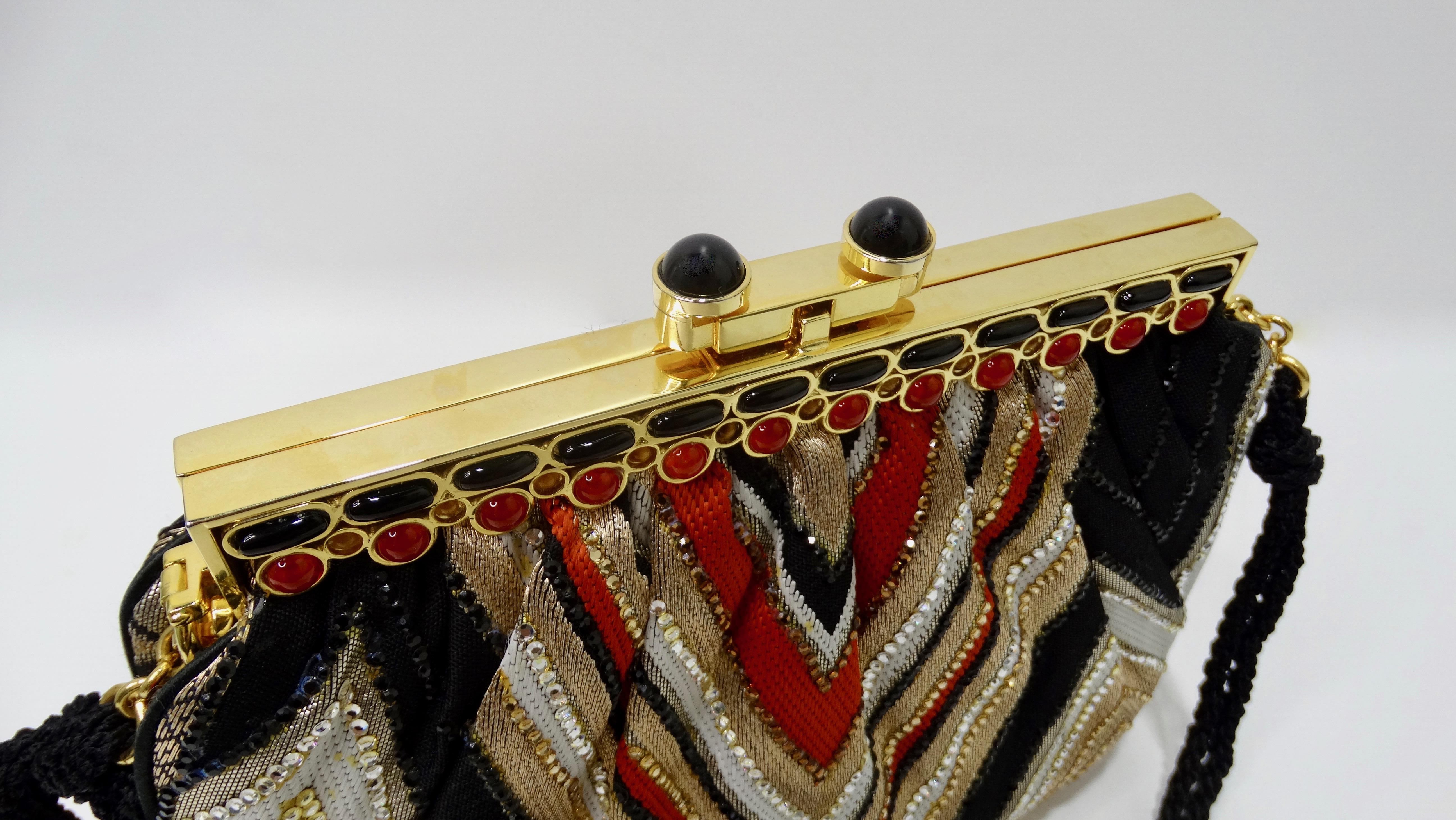 Take on the evening with this stunning Judith Leiber evening bag! Circa 1970s, this bag features a beautiful metallic gold, orange, white and black chevron motif finished with glittering multi-colored rhinestones. This bag has gold plated hardware,