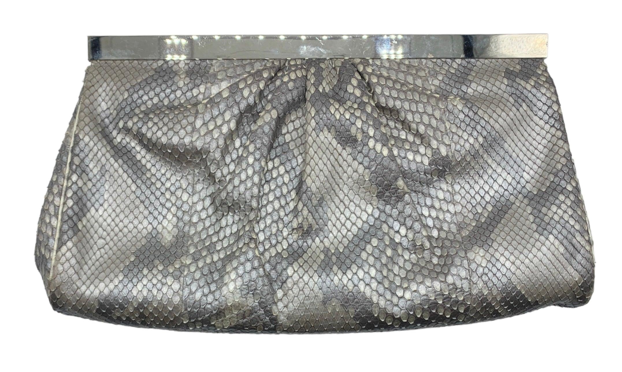 From the renowned handbag designer - Judith Leiber's stunning silver snakeskin evening bag. With intricate semi-precious stones and rhinestone deco detailing, this clutch is perfect for red carpet events and black tie affairs. The satin lining and
