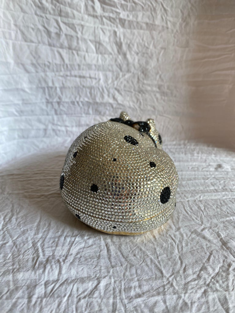 Gold-tone hardware in the shape of a sleeping cat, covered in silver and black spotted Swarovski crystals with a push lock closure. 

Condition: Great used condition. 
Exterior: Padded leather bottom, most stones intact.
Interior: Lined with