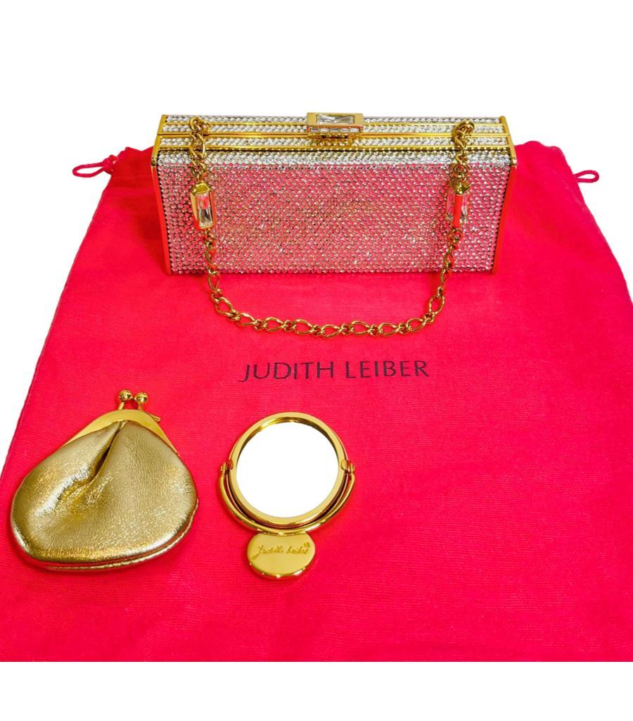 Judith Leiber Swarovski Crystal Embellished Bag With Matching Mirror & Coin Purse

Rectangular clutch bag designed with Swarovski crystals throughout and gold metal frame.

Styled with crystal studded push lock closure at the top leading to gold