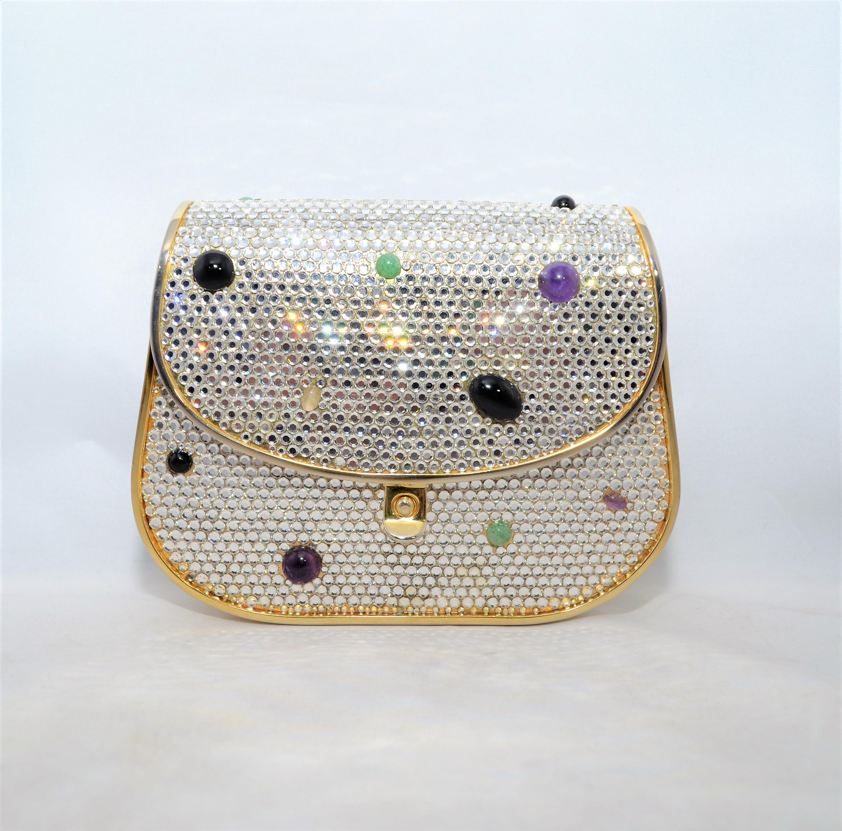 Judith Leiber Swarovski Crystal Minaudiere -- featured is a beautiful Judith Leiber minaudiere encrusted with swarovski crystals and semi-precious stones on a gold-tone metal frame with a flap closure. Minaudiere has a leather lining and an optional