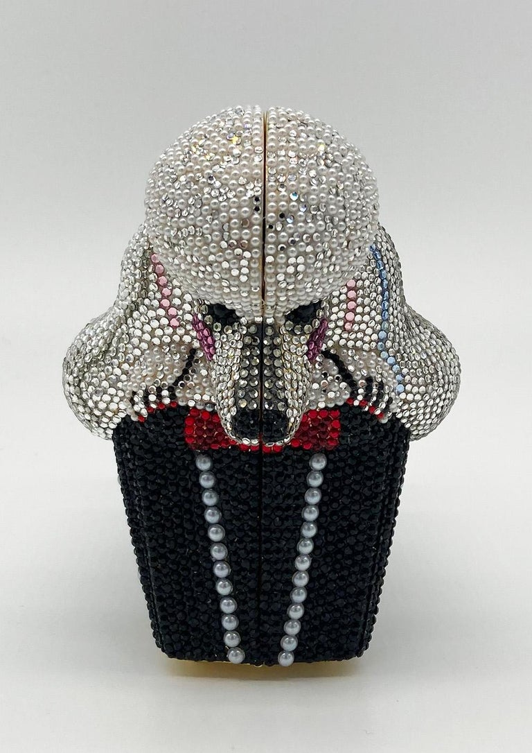 Adorable Judith Leiber Swarovski Crystal Poodle Box Minaudiere Evening Bag Wristlet in excellent condition.  Black, clear, pink, blue and grey Swarovksi crystal with pearl accents throughout exterior in a unique poodle box shape.  Top button closure