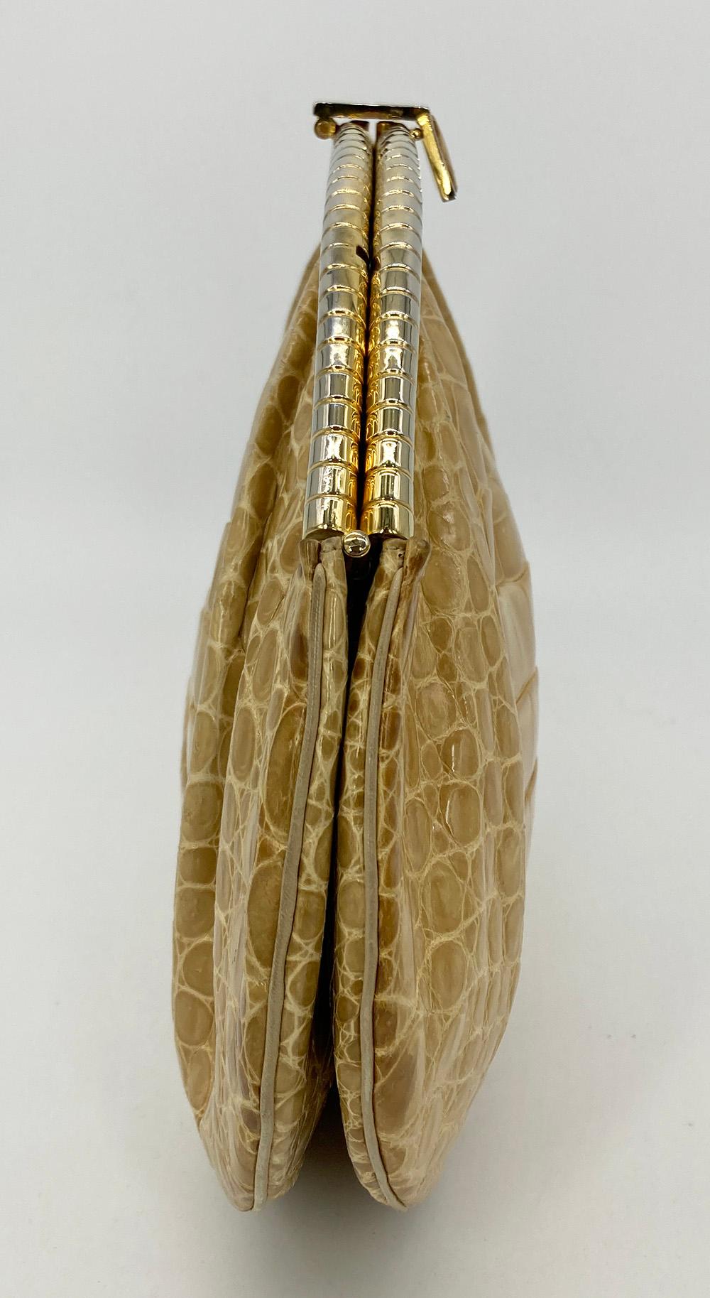 Judith Leiber Tan Alligator Clutch in good condition. Tan alligator exterior trimmed with gold hardware along top edge. Top center lift latch closure opens  via 4 hinges to a tan leather lined interior with one slit an done zip side pockets and