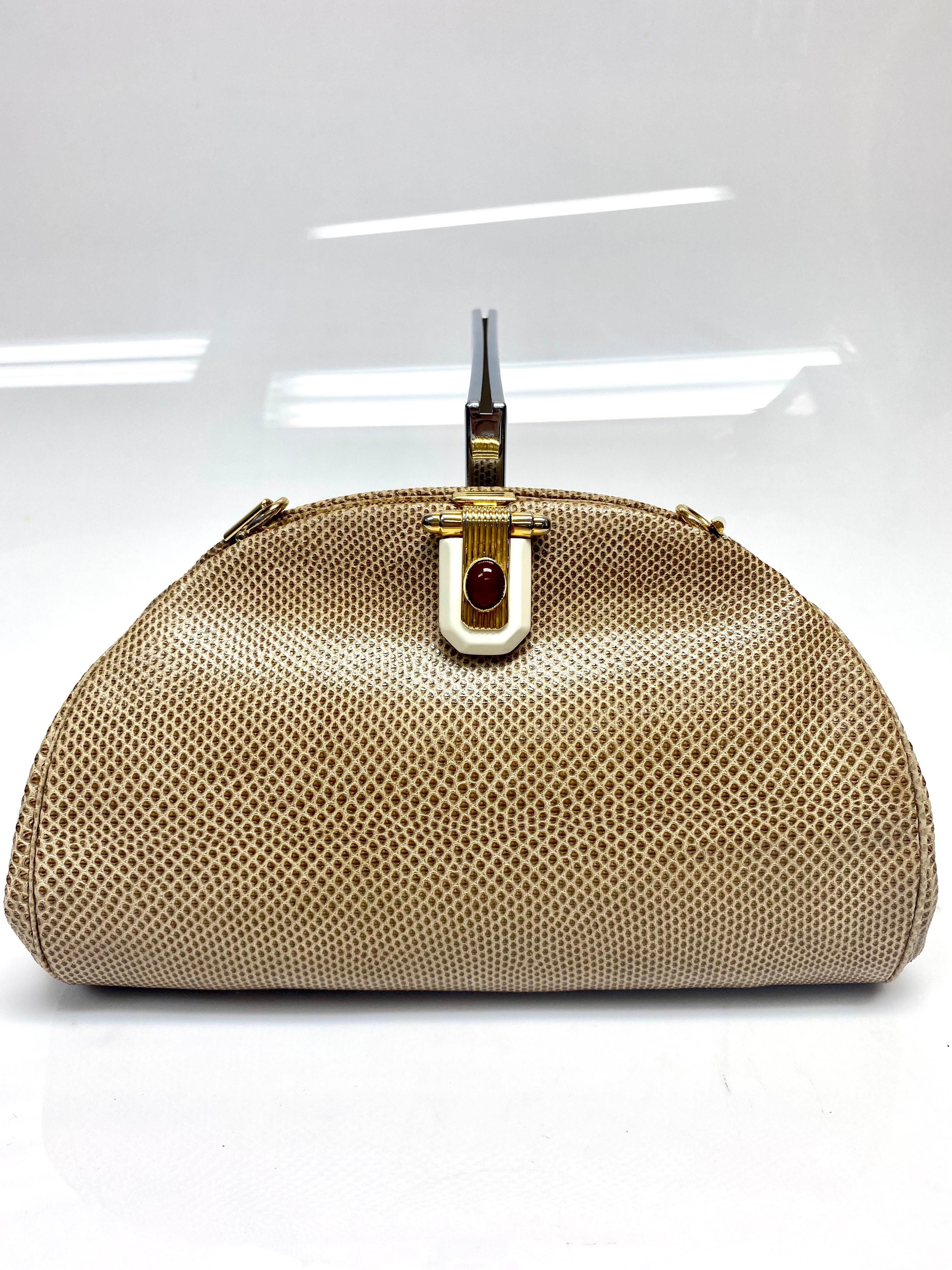 Judith Leiber Tan Karung Snake Handbag Clutch with Stone Buckle Front. A beautiful piece by the talented Judith Leiber, this karung snake clutch/handbag is a perfect bag for any occasion. Featuring ivory, red and gold hardware and a removable strap.