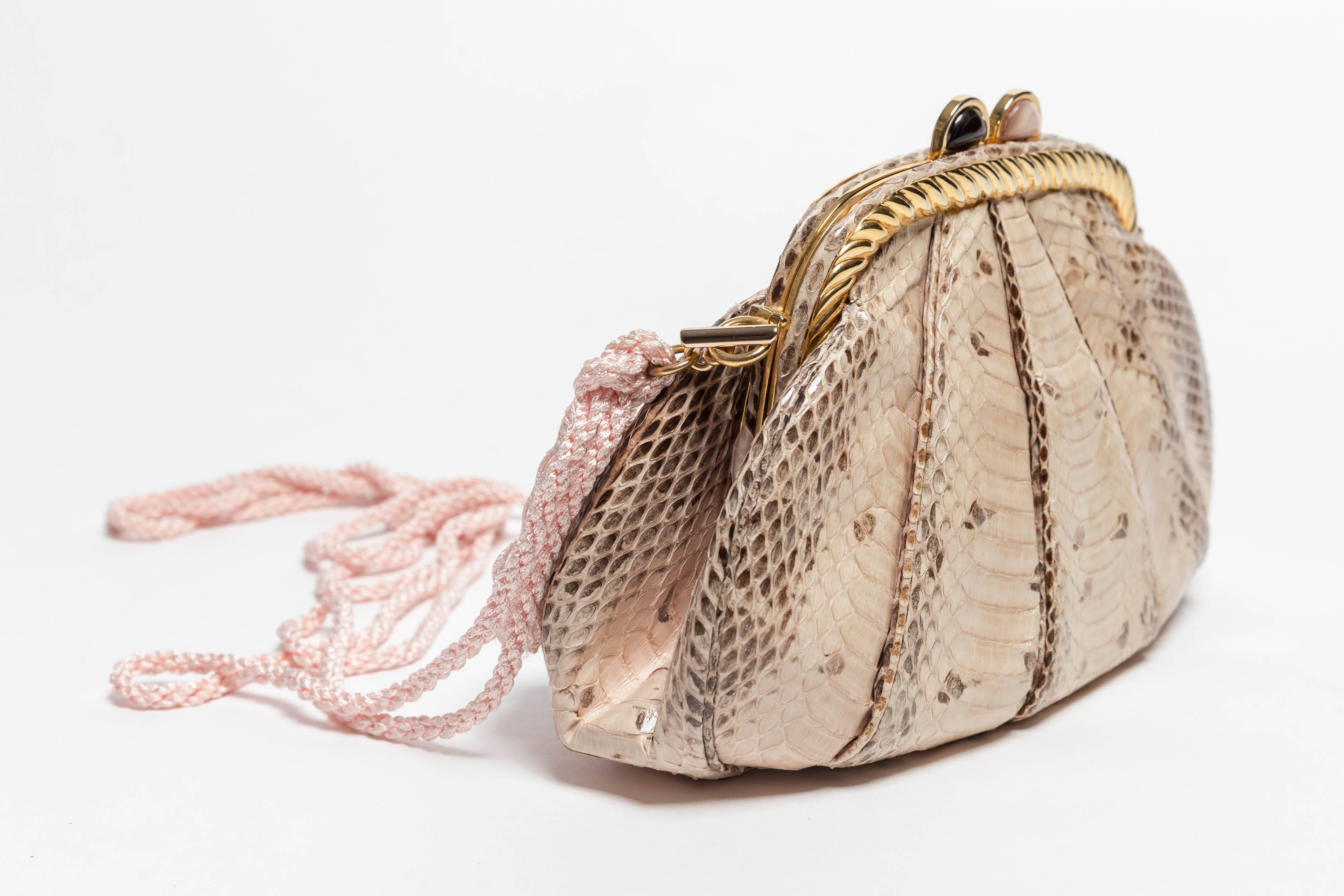Very pretty Judith Leiber python clutch with removable silk shoulder strap.
Gold trim with semiprecious stone embellishment.
Includes Judith Leiber mirror and change purse.
Condition is excellent.