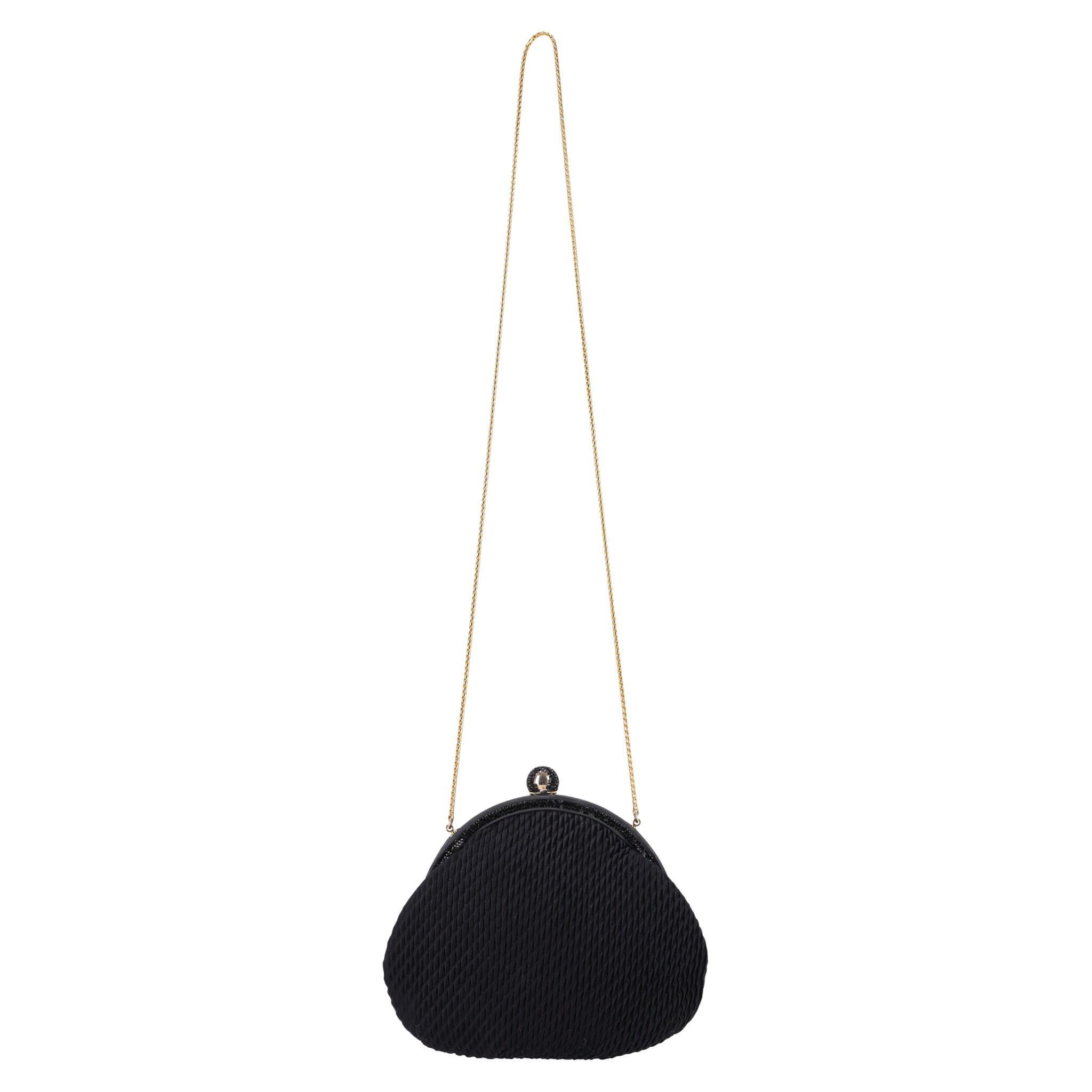Judith Leiber Vintage Crystal Adorned Satin Clutch Bag With Gold Comb

Black clutch bag crafted in textured satin with black crystal trim adornment.

Detailed with crystal encrusted ball closure leading to satin interior with branded, gold