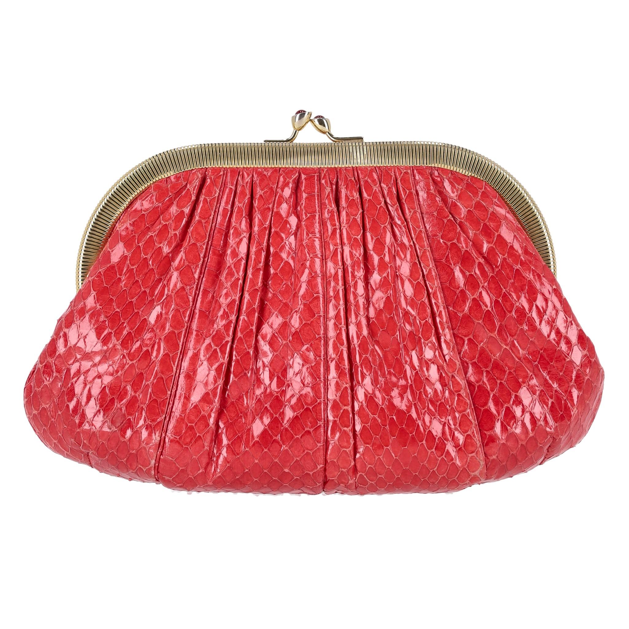 Judith Leiber Vintage Snake Skin Bag

Vintage handbag crafted from red snakeskin, features a structured, pleated body with a vibrant glossy finish.

The bag is adorned with a gold-tone metal frame and a classic kiss-lock closure embellished with red
