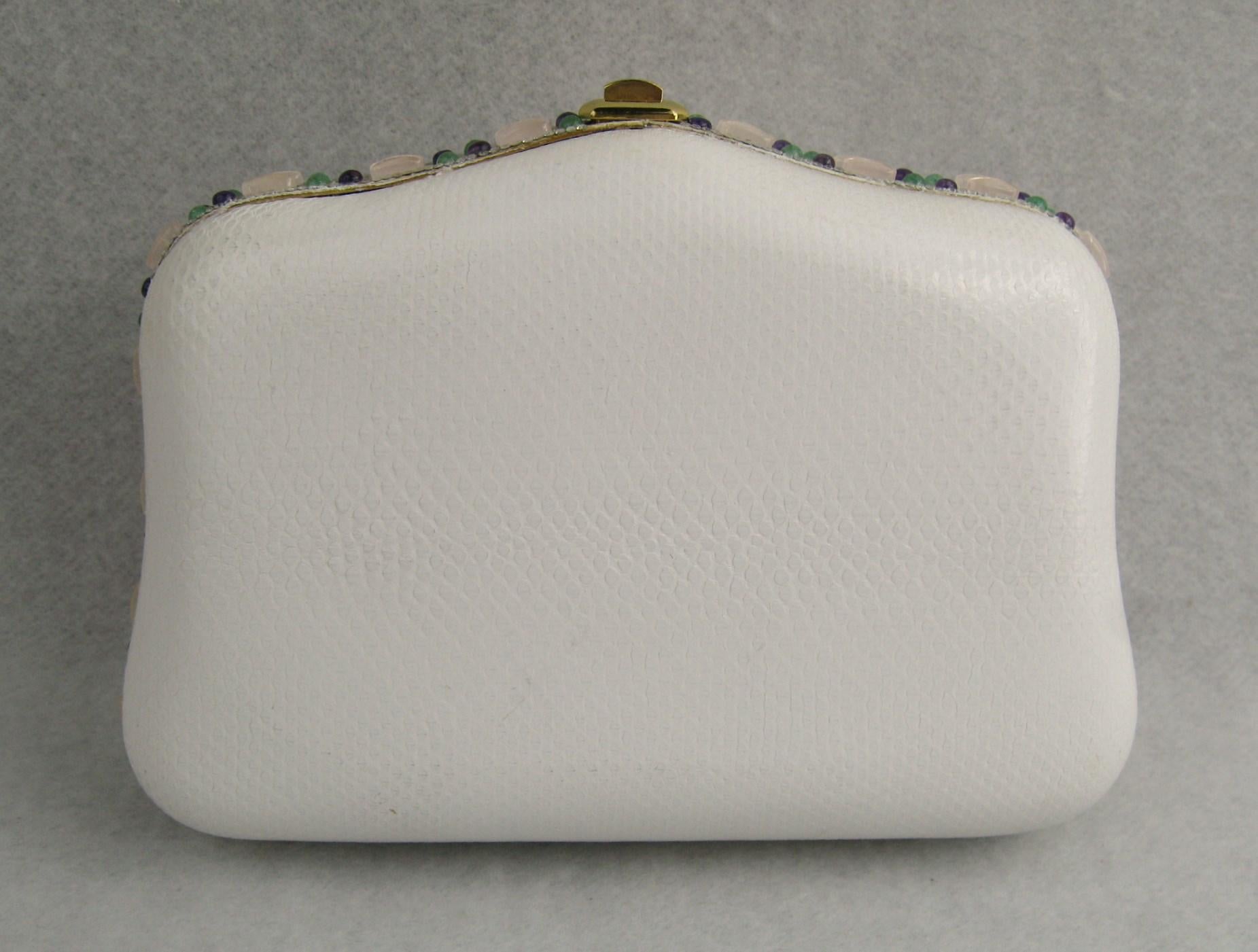 Wonderful Judith Leiber clutch! Totally surrounded by semi-precious stones. Converts from a clutch to a shoulder bag. Gently, gently used. Mirror in bag. Measures 7.25 in x 5 in. x 2.25 in. deep. It comes with an Original Judith Leiber Box it was
