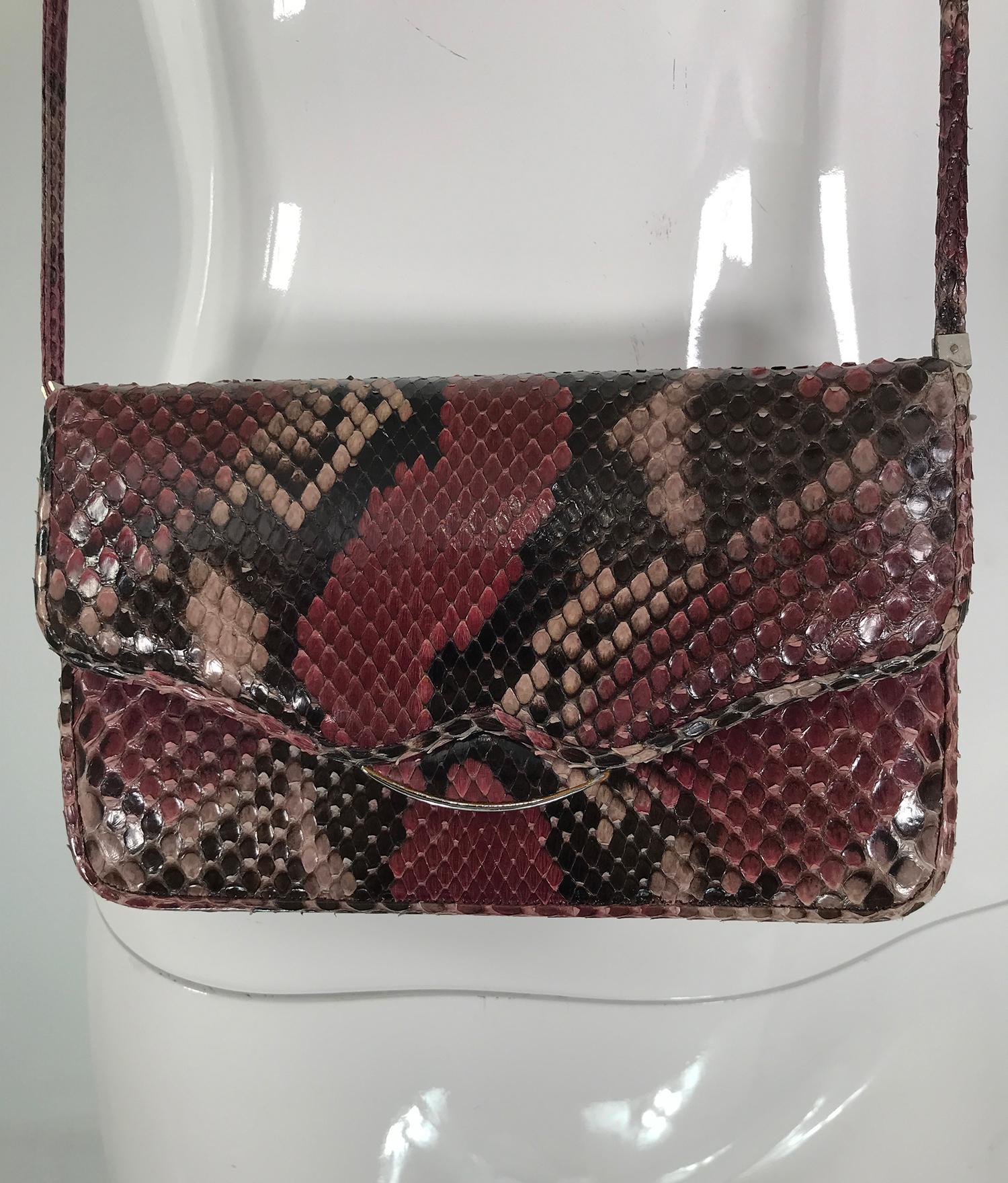 Judith Leiber wine & black snakeskin mini clutch or shoulder bag with silver hardware. Flap front bag with silver metal band at flap. Perfect for cocktails or any special occasion. Lined in wine satin, there is a single slip compartment and a single