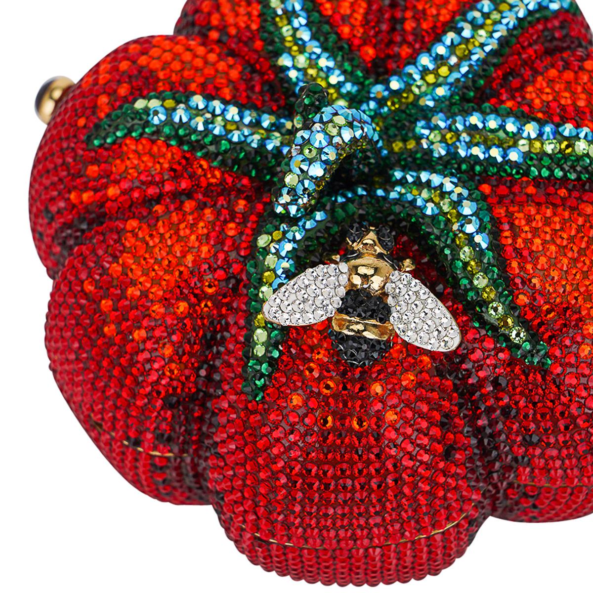 Utterly exquisite Collector's Edition Judith Leiber Couture Heirloom evening bag.
Crystal encrusted minaudiere in the shape of a tomato with a small bee.
Hand placed crystals in red, blue and green.
The bold bee is adorned with black and clear