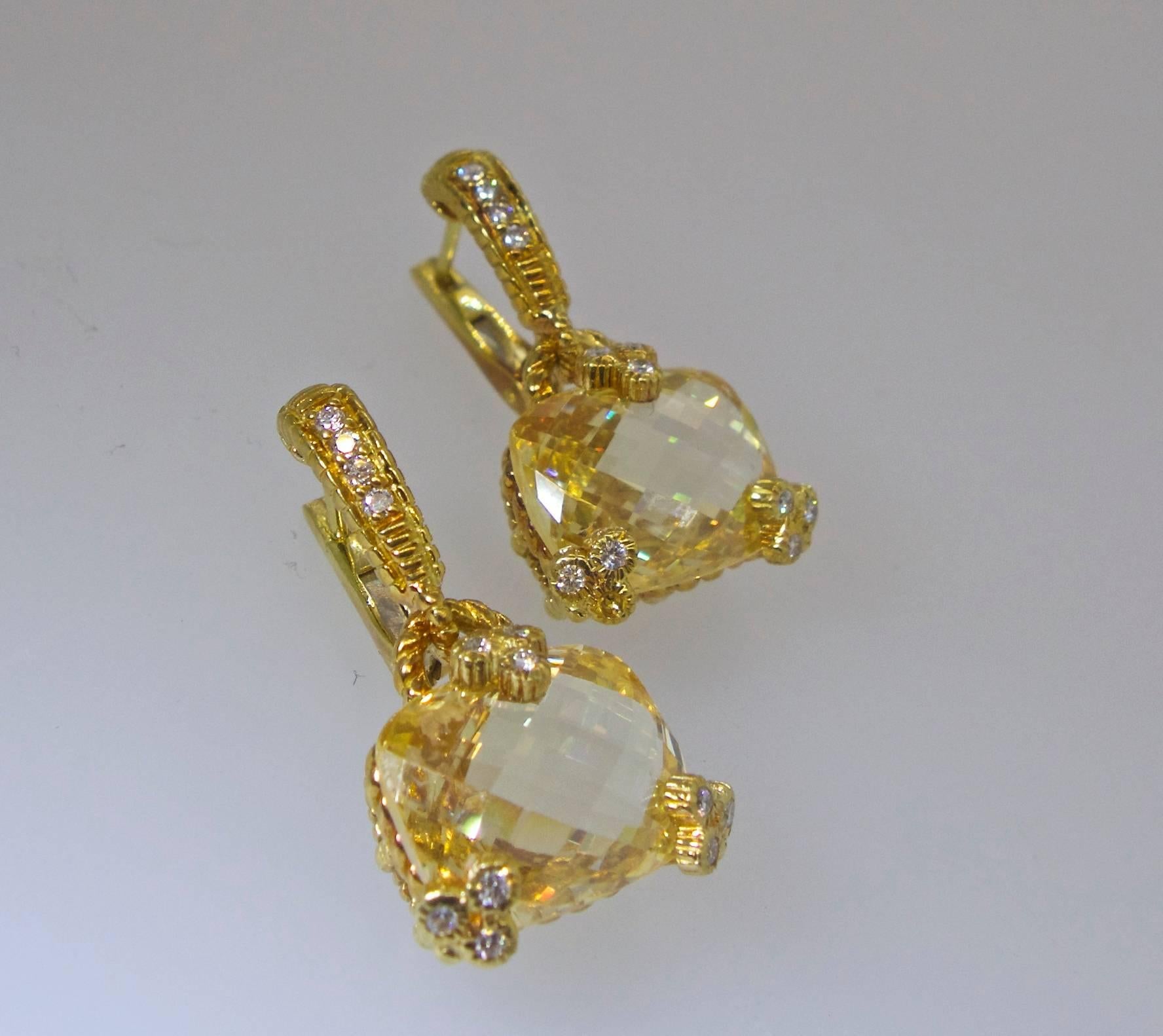The center Citrines have fancy faceted tables to reflect the light in all directions, there are small fine white diamonds accenting these center stones.  These 18K yellow gold earrings which are now for a pierced ear were made by the designer,
