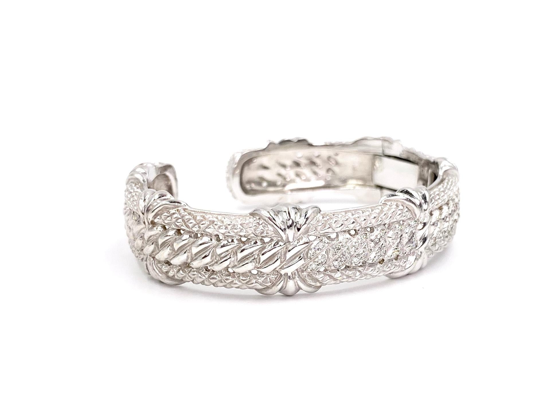 Heavy and substantial 11mm 18 karat white gold carved cuff bracelet with .48 carats of round brilliant diamonds encrusted over the top section. Diamond quality is approximately F color, VS2 clarity. Bracelet features both matte and polished