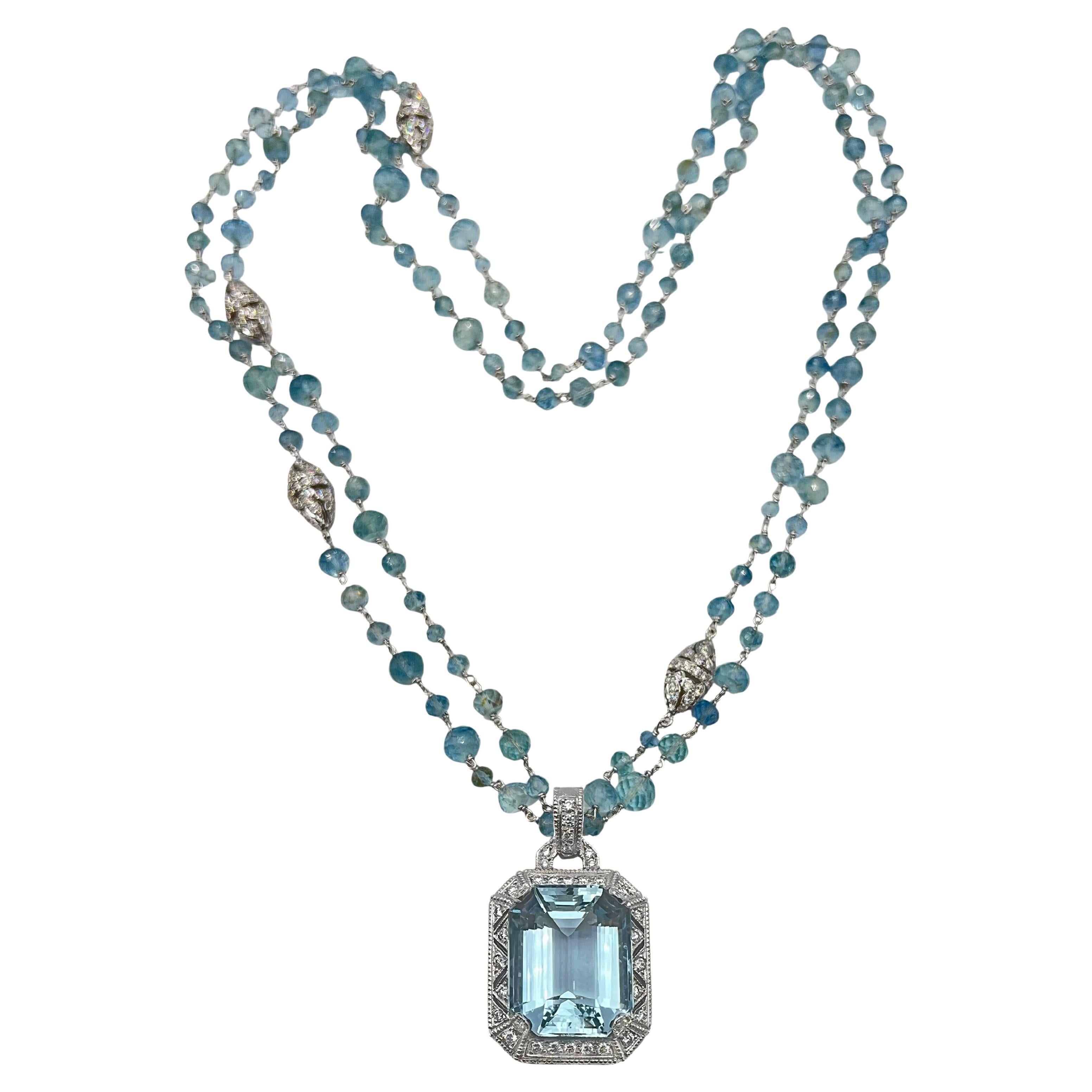 Judith Ripka aquamarine and diamond enhancer pendant suspended on an aquamarine bead and diamond-set bead long neck chain.  Aquamarine measuring 21.62 x 17.36 x 10.87mm and weighing approximately 30 carats.  Filigree-style 18k white gold mounting
