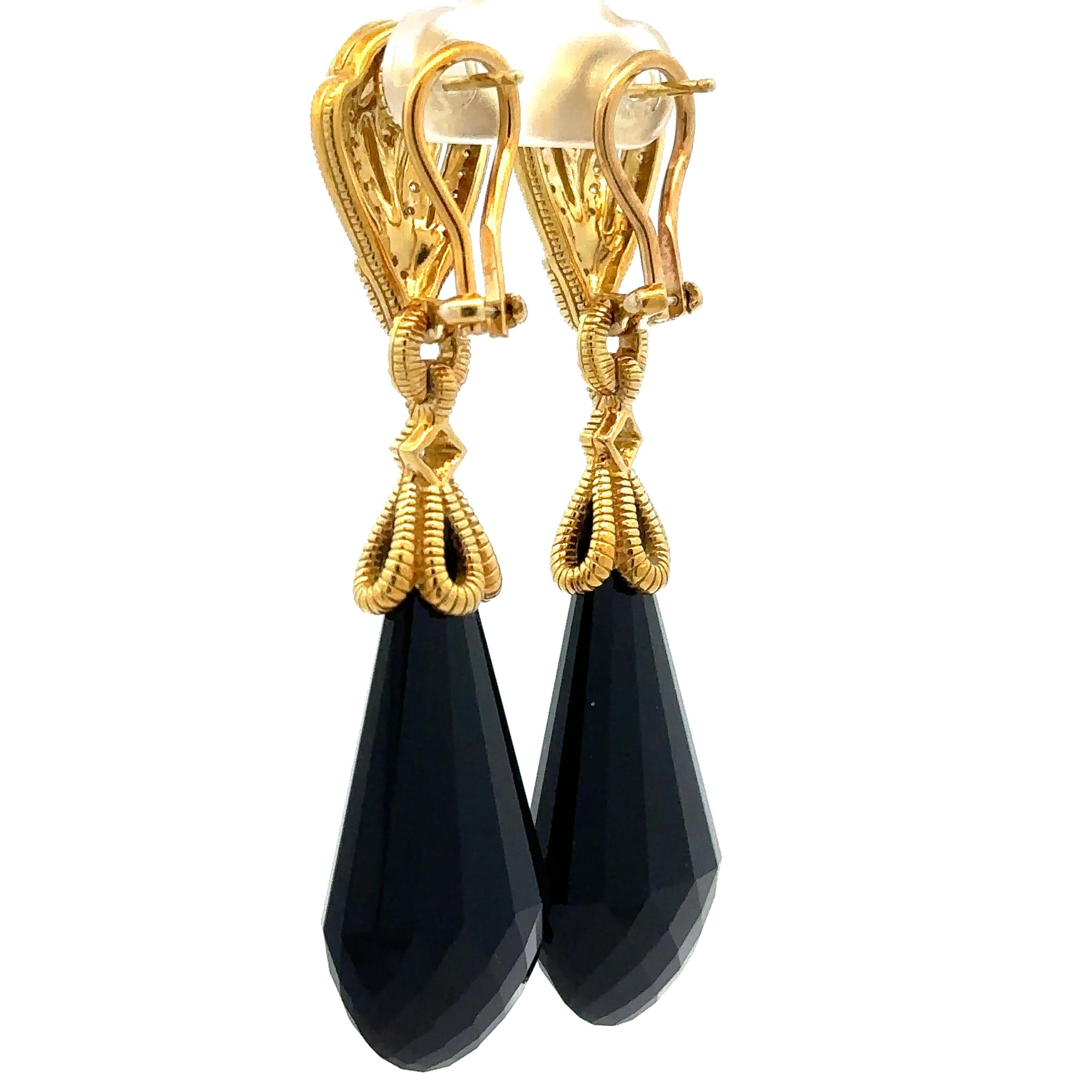 --Stone(s):--
(2) Black Stones- Faceted Tear Drop Cut - Black Color - 33.1x17.4mm (approx.)
(86) Natural Genuine Diamonds - Round Brilliant Cut - Pave Set - F/G Color - VS1/VS2 Clarity - 0.50ctw (approx.)

Material: Solid 18k Yellow Gold
Weight: