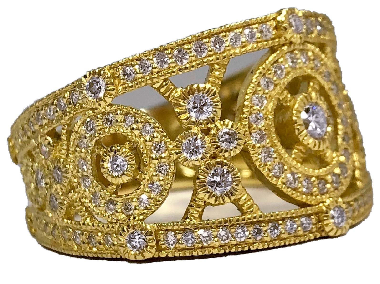 This classic Judith Ripka 18k yellow gold band ring is 5/8 inches wide at it's front and tapers gradually to 1/4 inches at the rear. It's set with over 100 round brilliant cut diamonds with a total approximate weight of 1.10ct and an overall quality