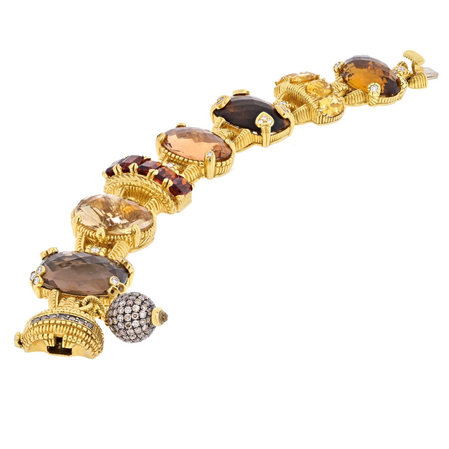 This is a stunning authentic bracelet by Judith Ripka, it is crafted from 18k yellow gold featuring 5 oval shape large gemstones with two curved frame links and 1 heart shape, all set with smoky quartz, citrine and peridot. Between some of the links
