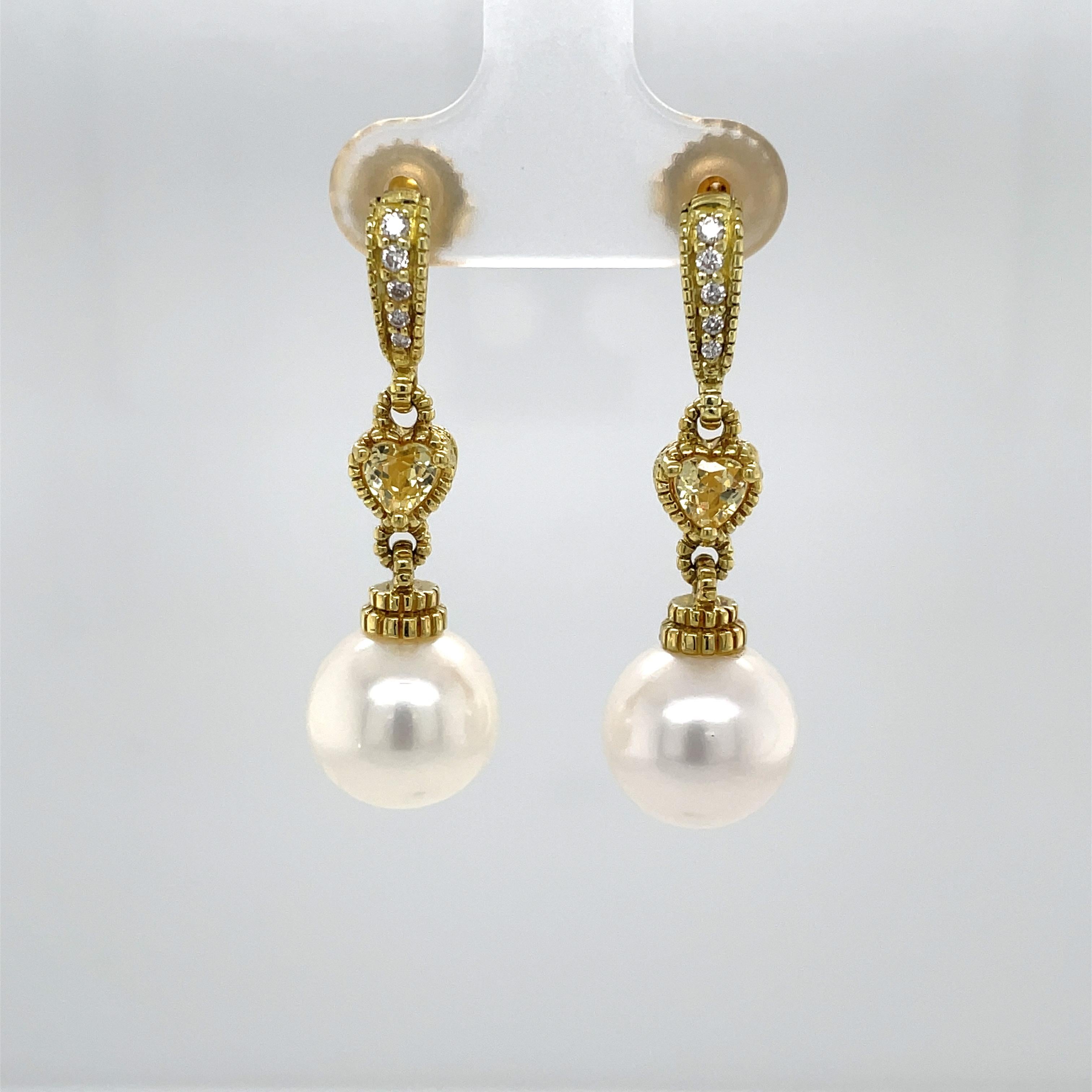 Sparking diamonds and warm yellow citrine heart shaped accents adorned this elegant pair of eighteen karat 18k yellow gold pearl drop earrings by well known jewelry designer Judith Ripka. Showcasing dangling round white 11 mm AAA freshwater culture