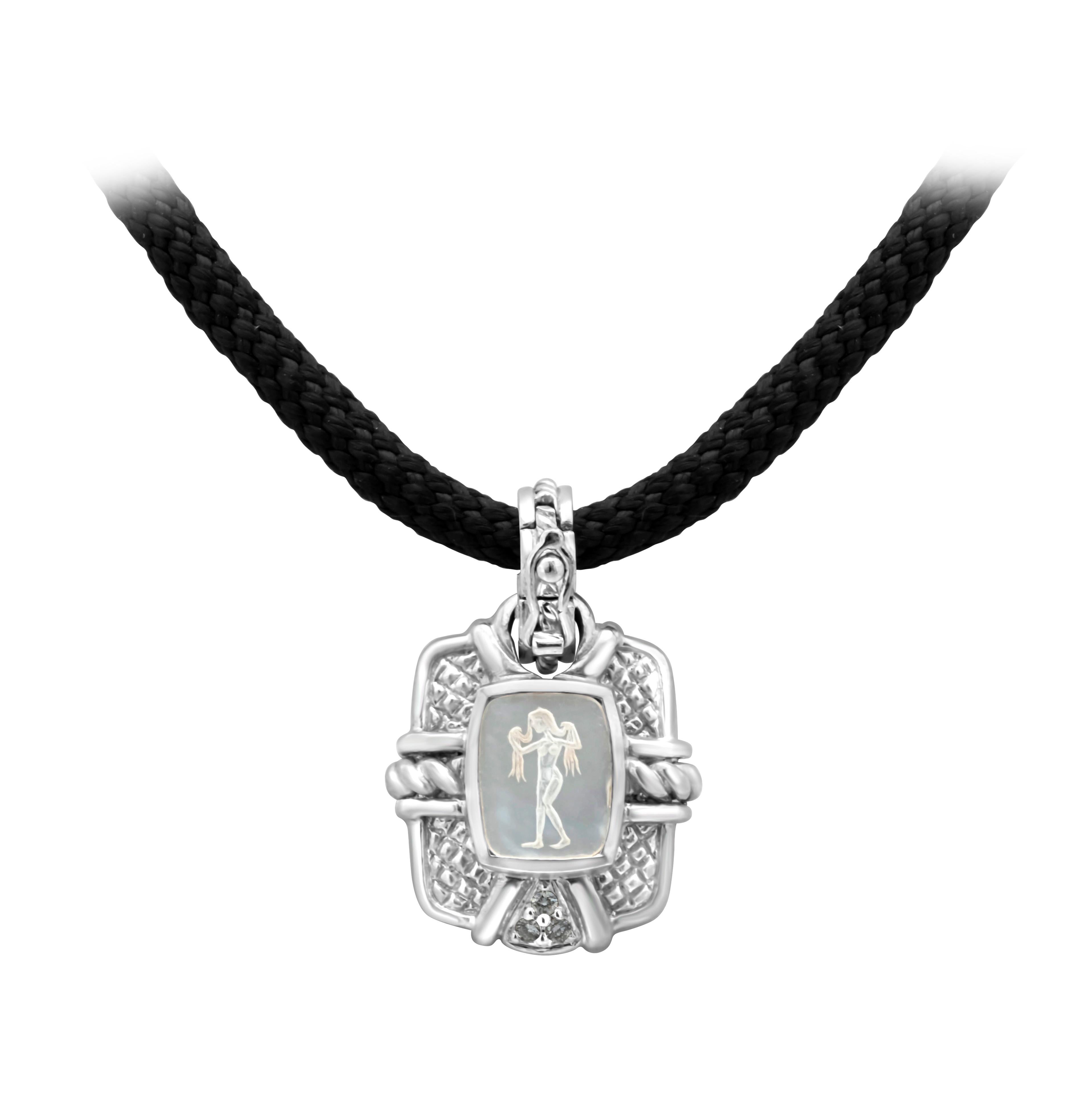 Judith Ripka Design showcasing an antique engraved pendant necklace with an embossed roman trojan in the center, With a diamond encrusted bail. Suspended on black silk cord. Finished with a filigree engraved white gold clasp.