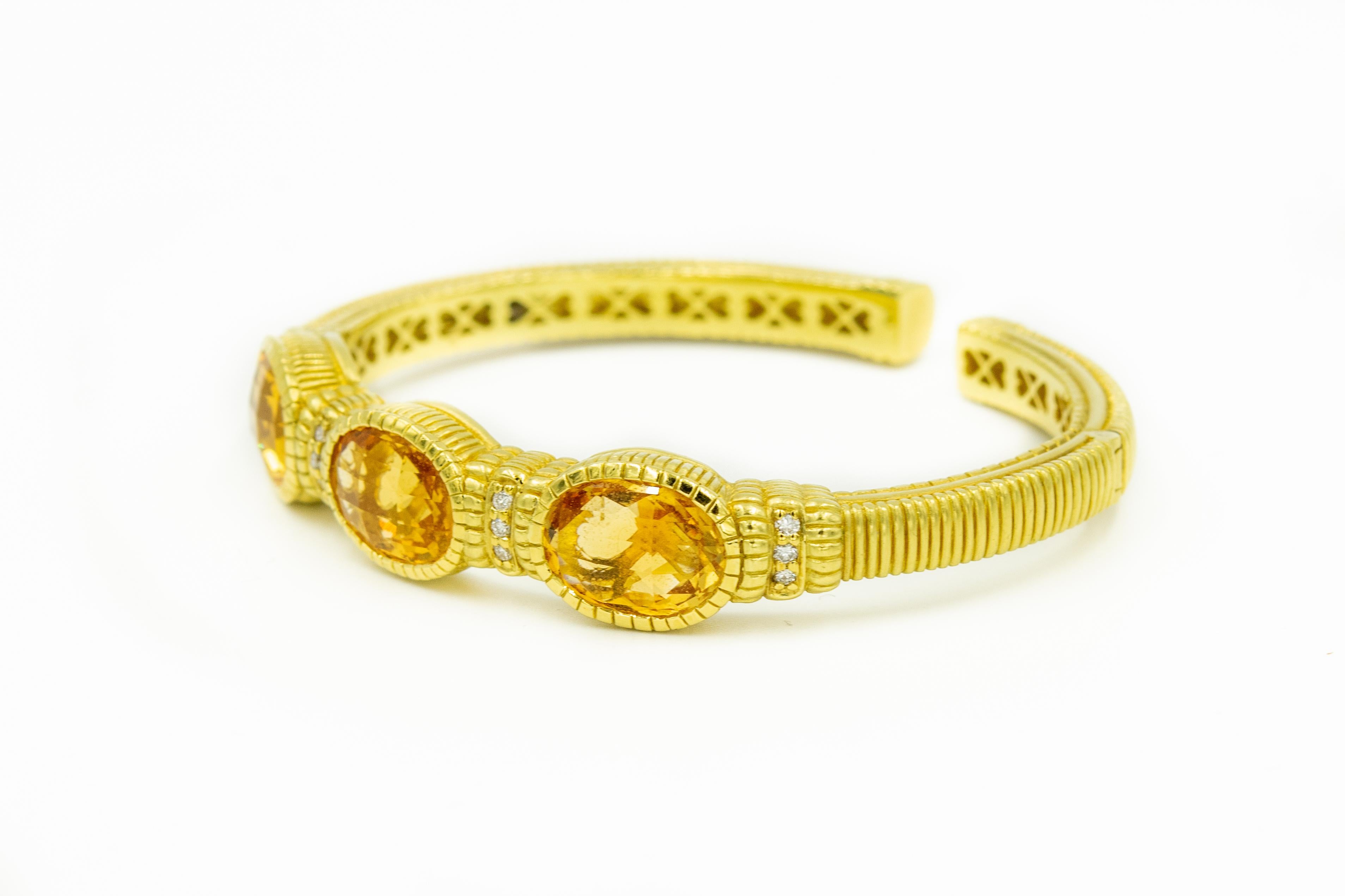 Textured 18K yellow gold Judith Ripka cuff featuring three checkerboard oval citrine with 0.12 carats of round brilliant cut diamond accents and hinge closure. It weights 35.85 grams.

Measurements: Interior circumference is 6