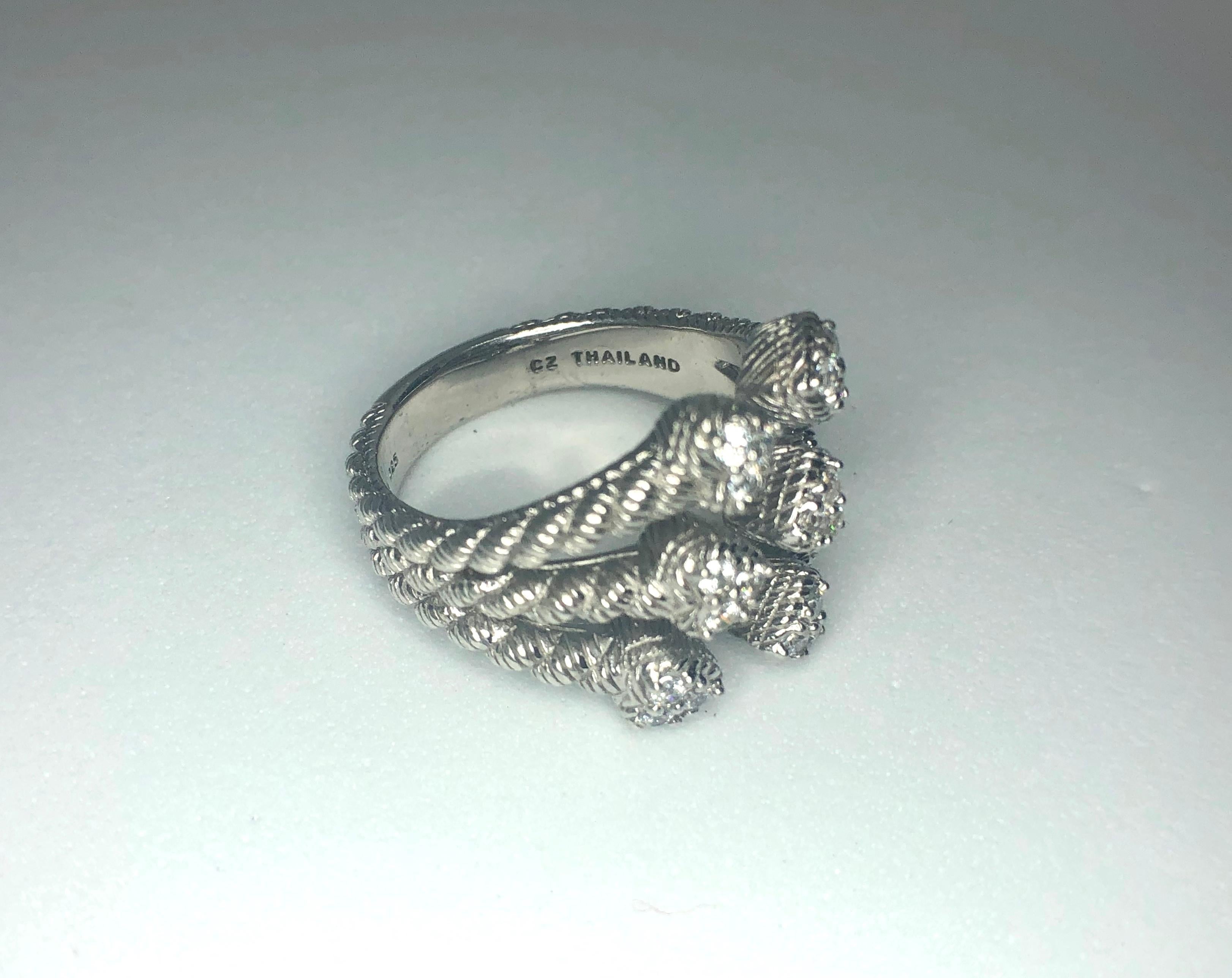 This is an sterling silver Judith Ripka ring with a split shank design with hearts. Each heart boasts sparkling cubic zirconias. Size 9
