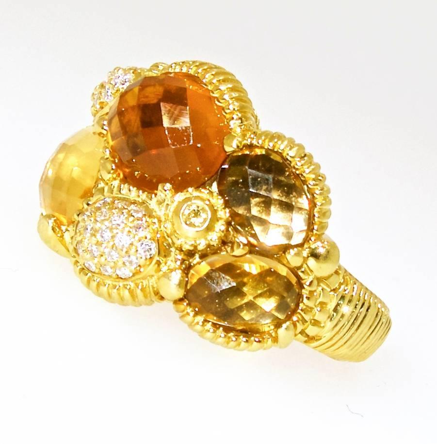 Contemporary in design, this ring by Judith Ripka has multi color Citrines, from lemon yellow to Madeira to Root Beer colors - all the stones have faceted tables to reflect the light and further accented with white brilliant cut diamonds - all near