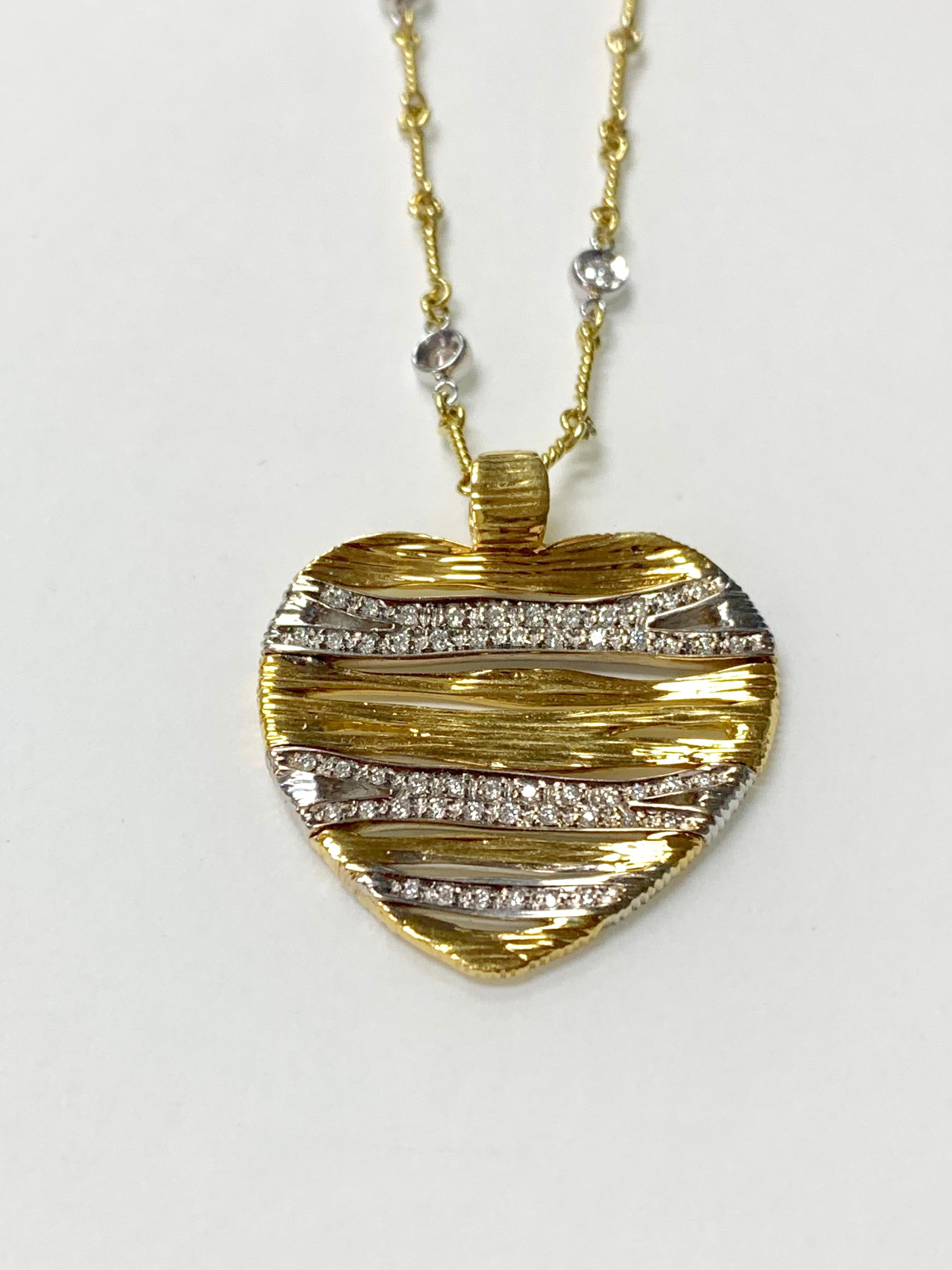 Beautifully hand crafted heart necklace with bezel set diamond chain in 18k yellow gold. 
The details are as follows: 
Diamond weight : 1 carat ( GH color and VS clarity ) 
Metal : 18k white gold 
Measurements : 1.35 by 1.25 inches
