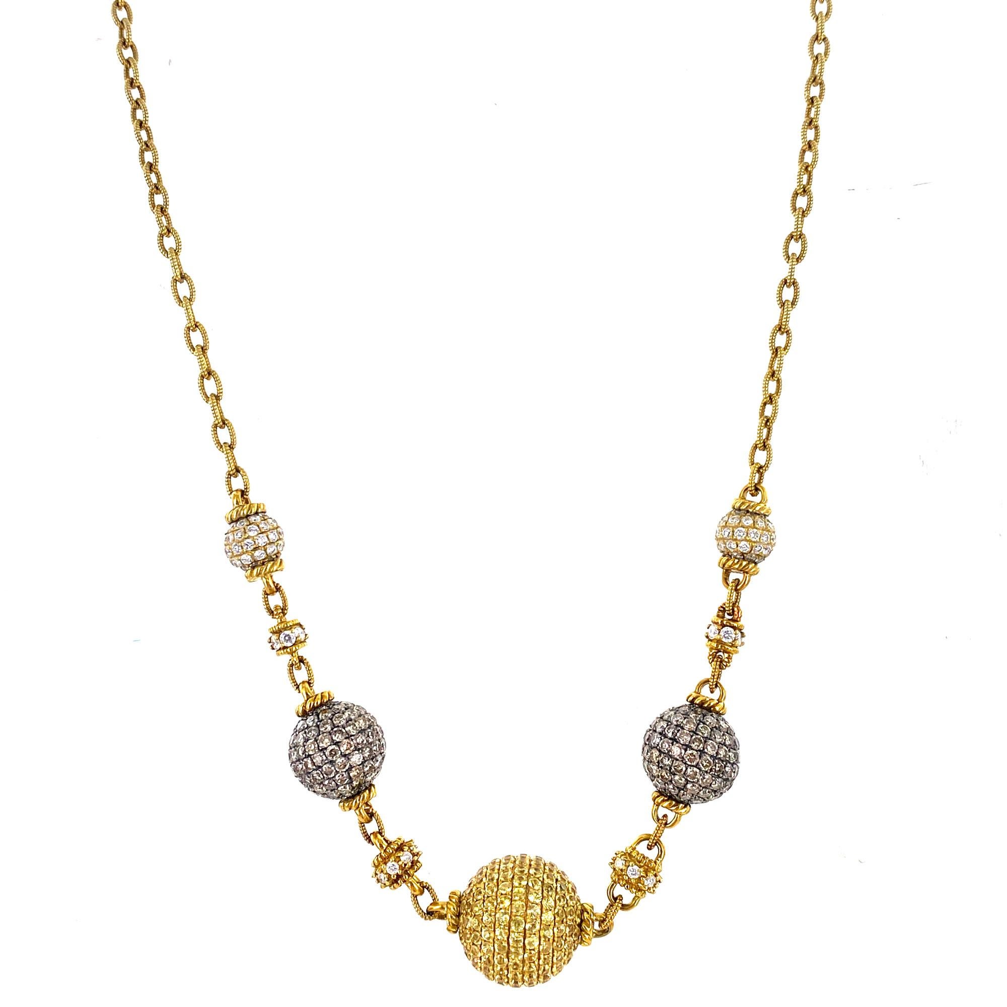 Fabulous diamond and sapphire ball necklace by Judith Ripka. The necklace is crafted in all 18 karat yellow gold and measures 17 inches in length. The white diamond and champaign diamond balls feature 5.50 carat total weight diamonds. In the center