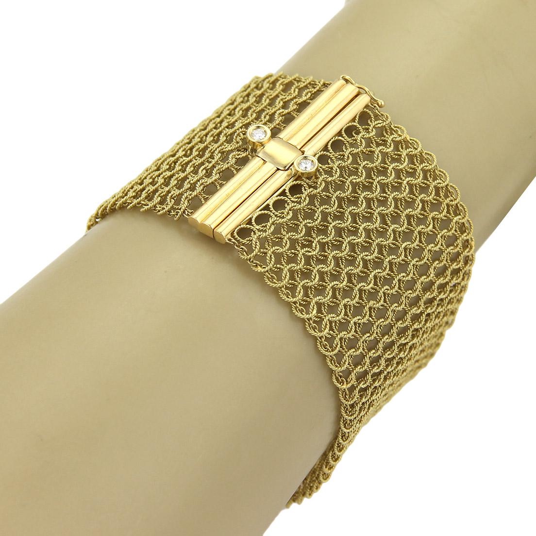 This is a magnificent authentic bracelet from Judith Ripka, it is crafted from solid 18k yellow gold in a polished and textured finish. The impressive 40mm width consist of fine wire cable set in an intricate interlace pattern following along 1.5