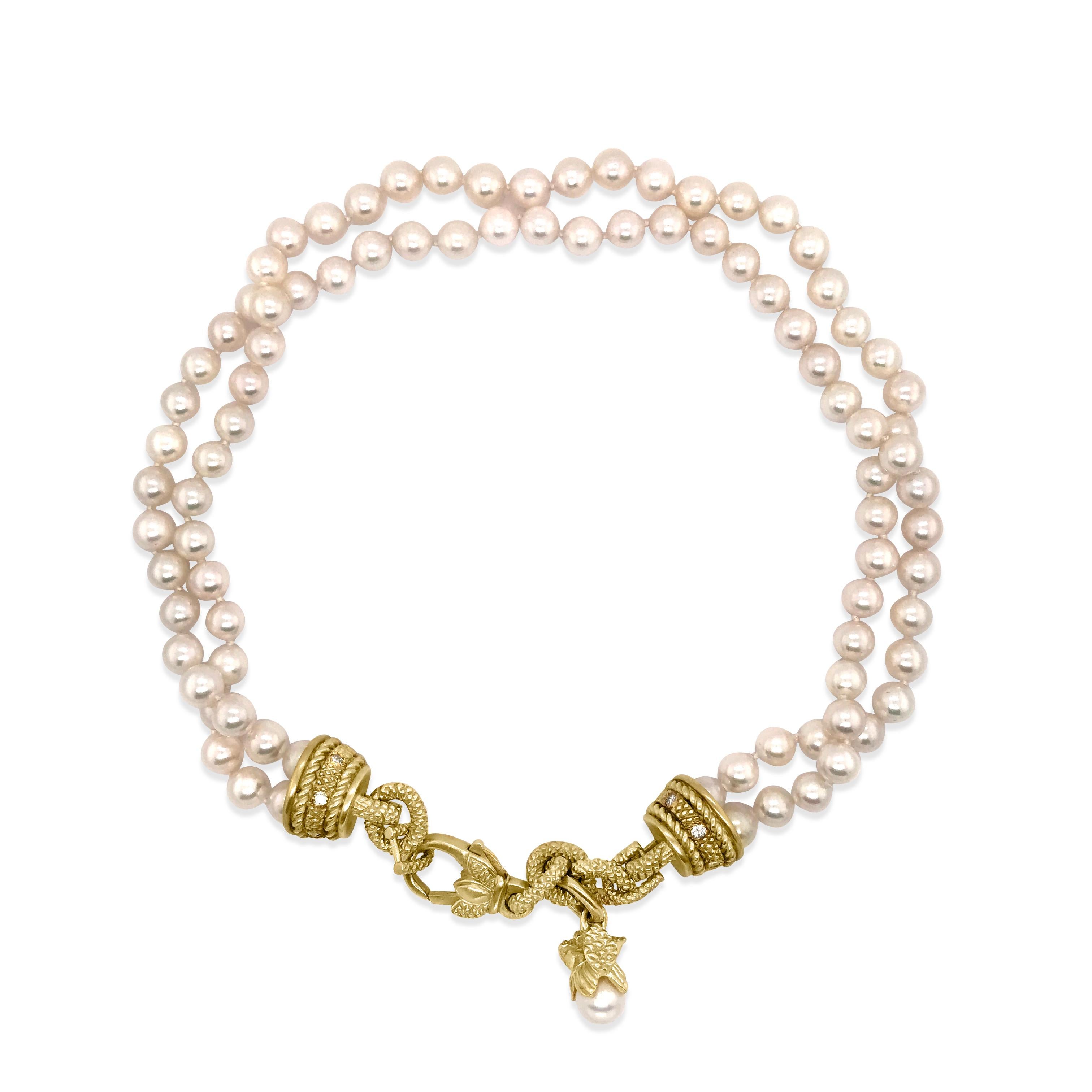 This collectible Judith Ripka pearl and gold necklace is crafted in 18K and 14K yellow gold. It comprises 4 strands of lustrous silk-strung cultured pearls of an enchanting 'pinkish-white' color, approx. 7.5 mm in diameter. The necklace composed of