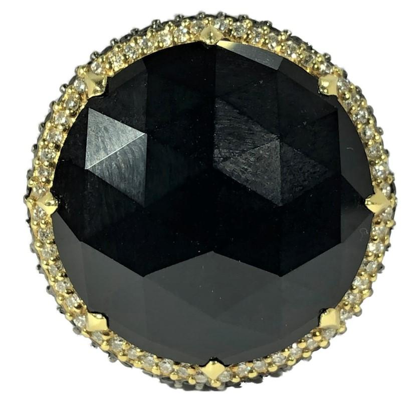 This Judith Ripka ring is crafted from 18k yellow gold and is not only striking in appearance but is intricately detailed, as well. At it's center is a 13/16 inch round faceted black onyx dome and that is surrounded by a bezel set with 56 brilliant