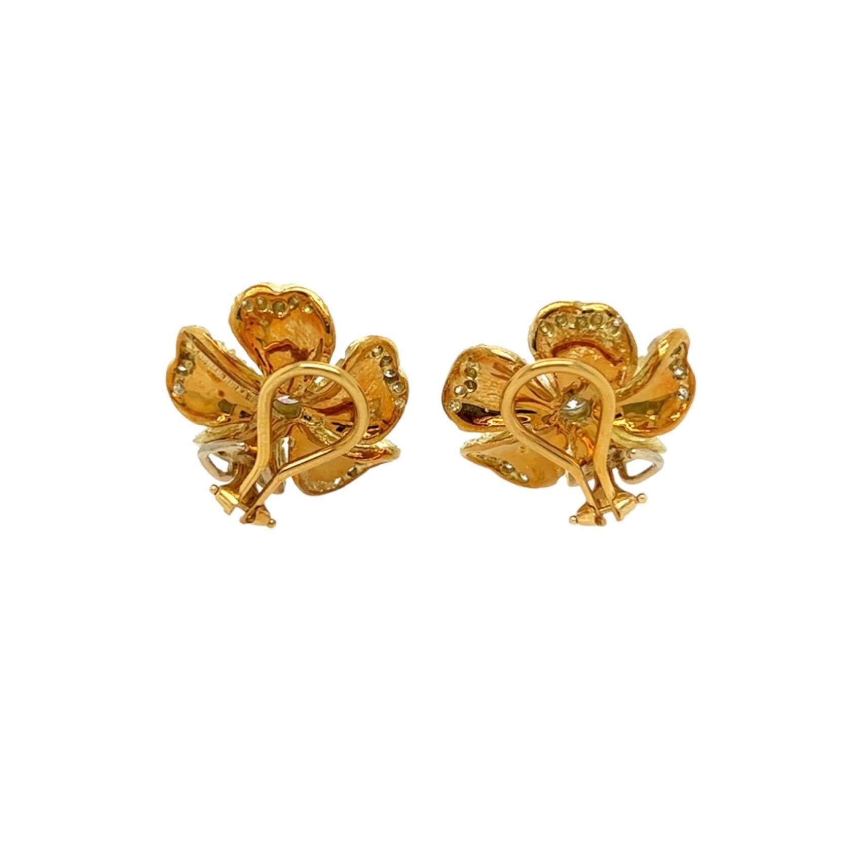 A pair of 18 karat yellow gold and diamond earclips, Judith Ripka.  Each earclip designed as flower with matte gold textured petals, the curling edges of the petals set with twenty five (25) round brilliant cut diamonds, the flower centering a bezel