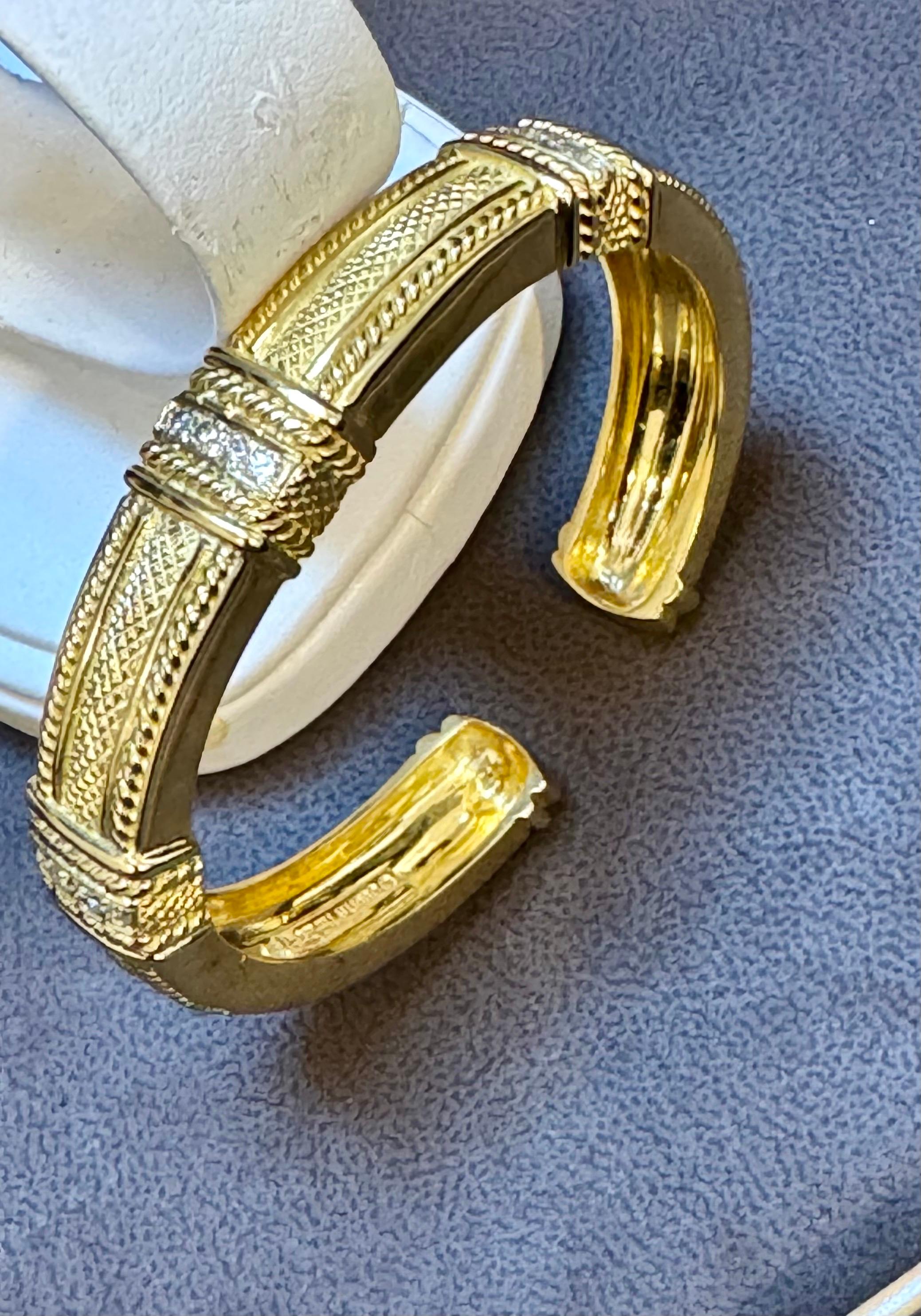 
Dazzling Judith Ripka Hinged Gold and Diamond Bangle Bracelet with Diamonds
This classic, vintage Judith Ripka bangle bracelet is aptly described as 