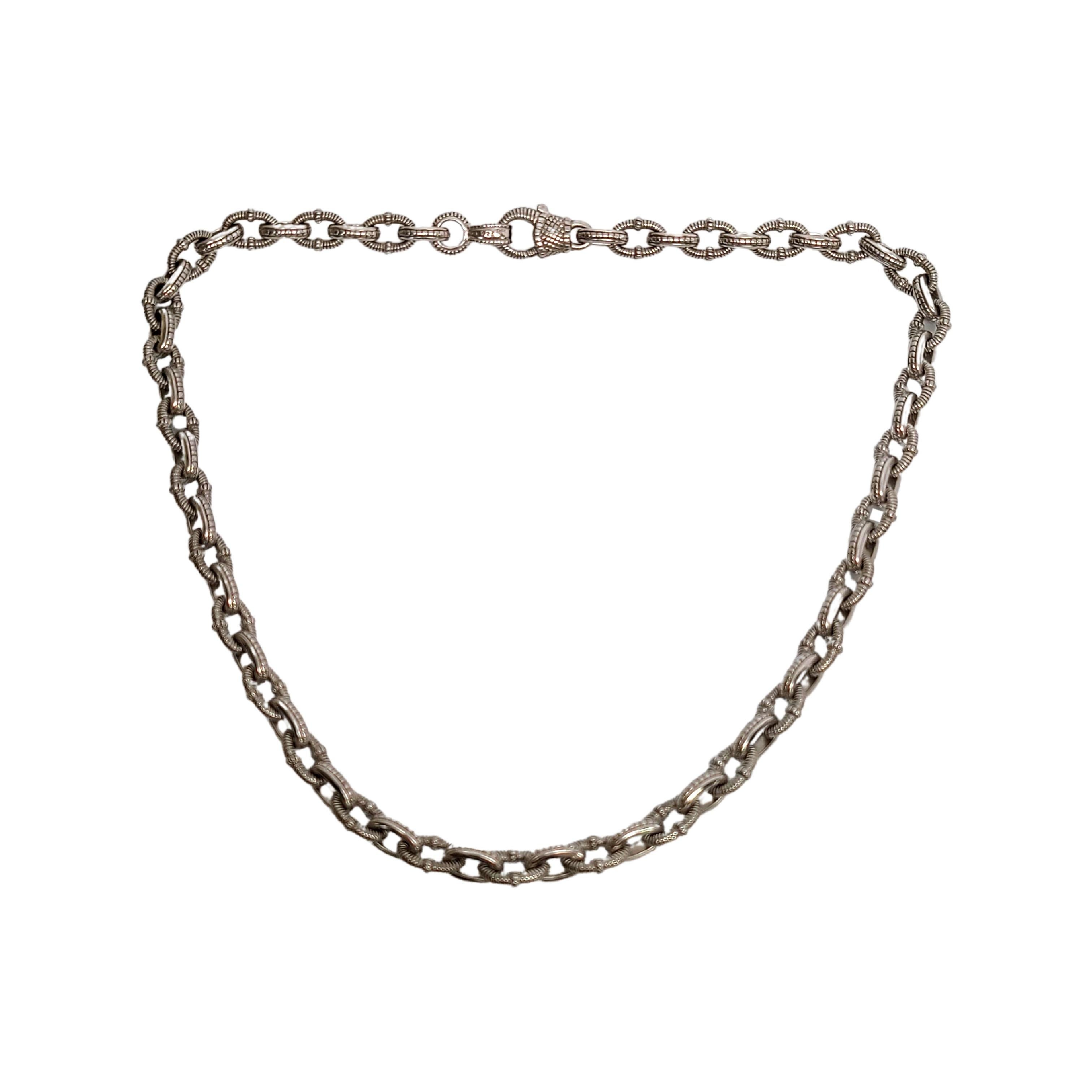 Sterling silver textured link necklace with 18K plated and diamond accent clasp, by designer Judith Ripka.

This beautiful piece features alternating textured and beaded oval elongated links. Textured clasp features a small gold accent with a small