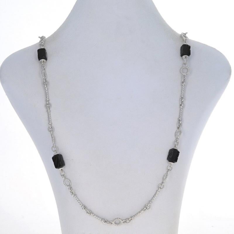 Brand: Judith Ripka

Metal Content: Sterling Silver

Stone Information
Natural Onyx
Cut: Carved Bead & Cabochon
Color: Black
Stone Note: (two small clasp accents)

Chain Style: Fancy
Necklace Style: Chain Station
Fastening Type: Toggle