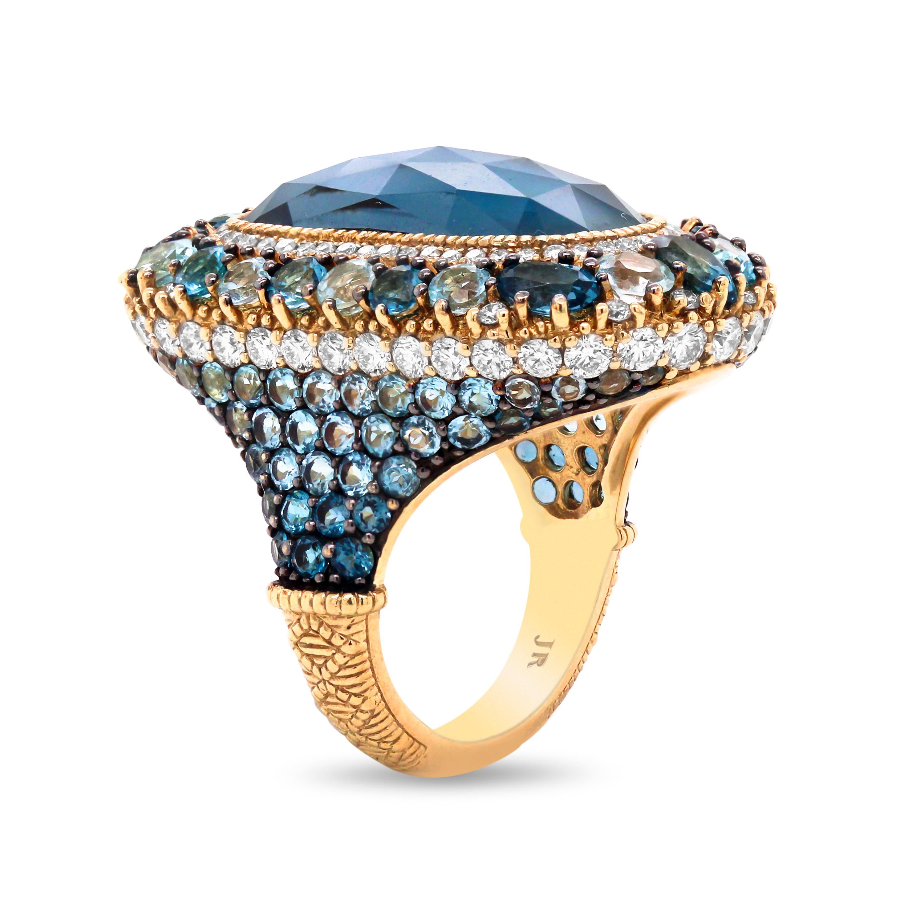 Judith Ripka Shaded Blue Sapphires Diamond Blue Topaz 18K Gold Cocktail Ring

This unique and extravagant ring features shaded blue sapphires with light blues to darker blues leading to a section of diamonds. The face of the ring has round and oval