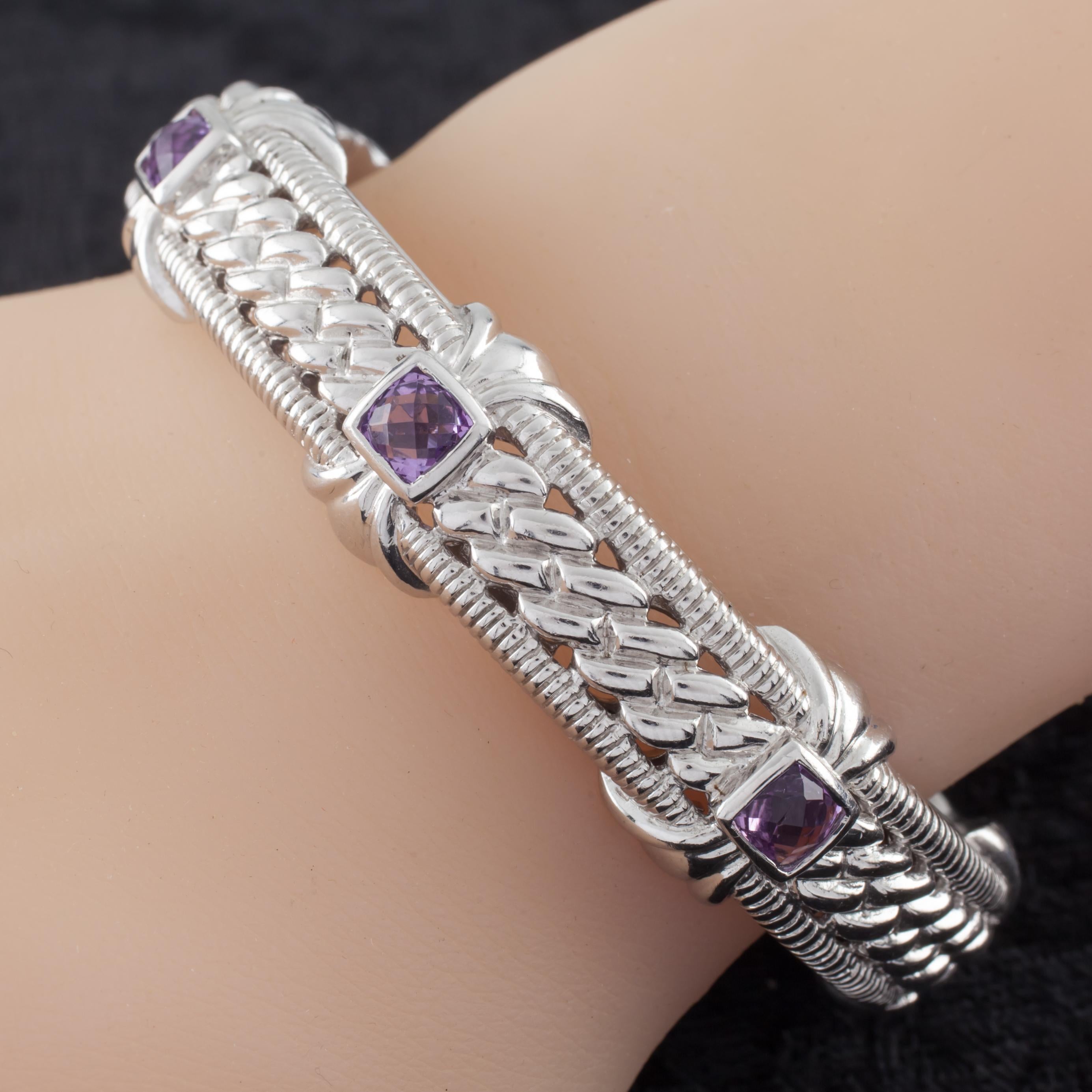 Gorgeous sterling silver cuff bracelet by Judith Ripka.
Features three (3) cushion cut and bezel set amethysts.
Width: 11 mm.
Size: 6.5 inches.
Metal: 0.925 sterling silver.
Weight: 47.9 grams.