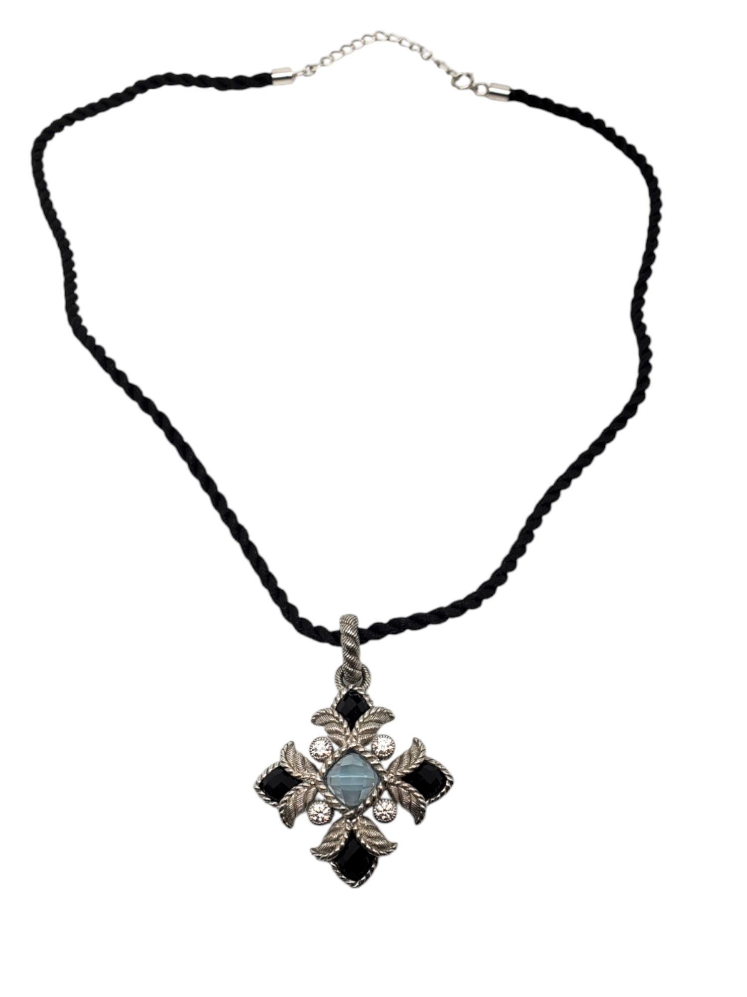Judith Ripka Sterling Silver Blue Topaz With Onyx & CZ Maltese Cross -

This lovely Maltese cross features a blue topaz center (8.03mm x 8.03mm) with onyx and CZ set in sterling silver with enhancer on a 16in. black cord.

Size: 46.40mm x