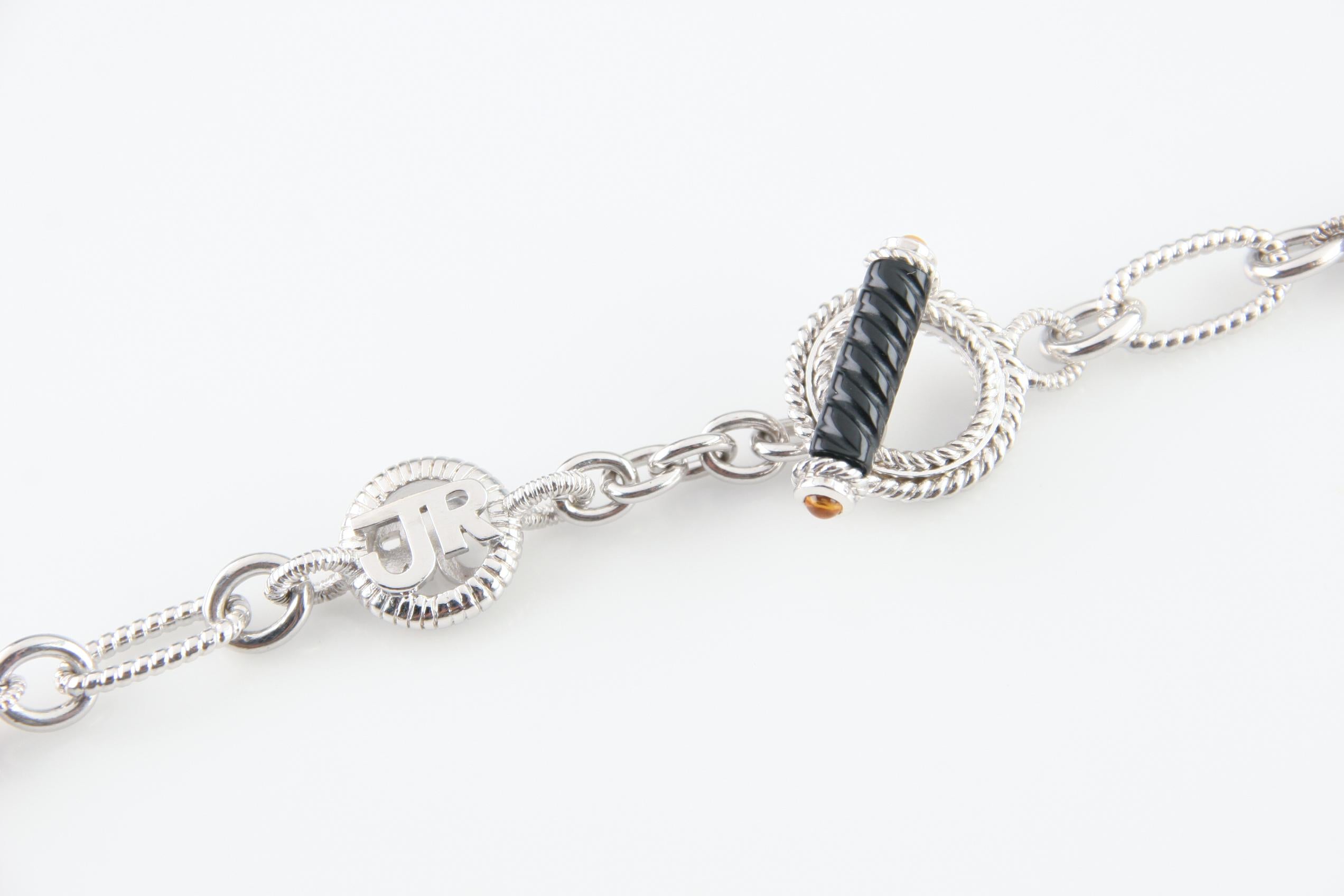 Splendida collana a catena in argento sterling di Judith Ripka.
Presenta 12 perle di quarzo fumé con taglio briolette.
Termina con una chiusura ad alamaro con un accento di onice e cabochon di topazio.
Peso: 50,8 grammi.
Lunghezza: 22 pollici.
Un