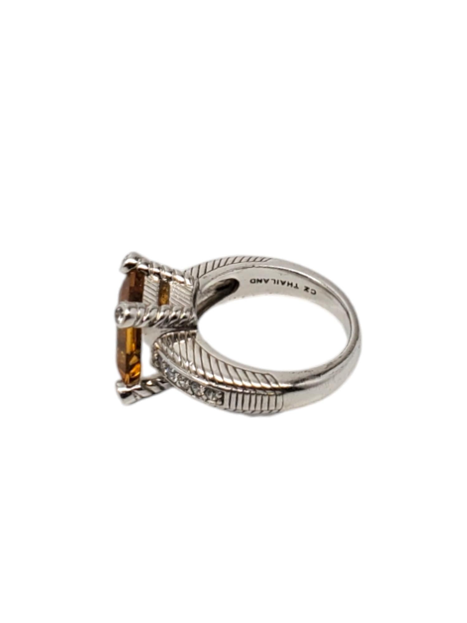 Judith Ripka Sterling Silver Citrine & CZ Ring Size 8.25

This vintage ring by Judith Ripka features a large emerald cut citrine stone (11.85mm x 9.95mm) with cz side accents set in sterling silver.

Width: 1.70 mm .

Shank: 3.29 mm.

Size:
