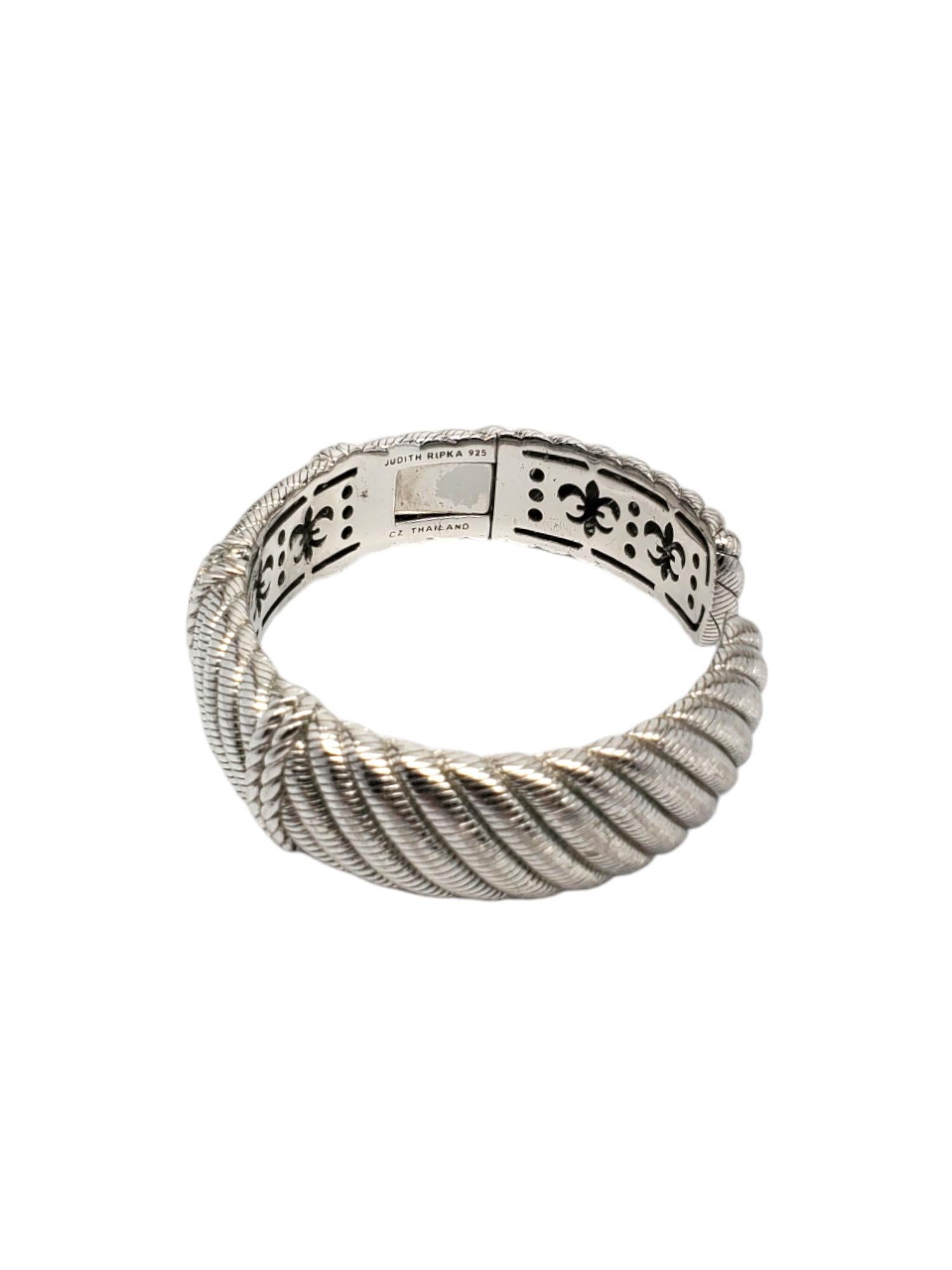 Judith Ripka Sterling Silver Cuff Hinged Bracelet 

This elegant wide cable hinged cuff bracelet features cz set in a textured sterling silver design by Judith Ripka.

Size: 7.25 in.

Stamped: JUDITH RIPKA 925 CZ THAILAND

Weight: 49.82 dwt./ 77.48