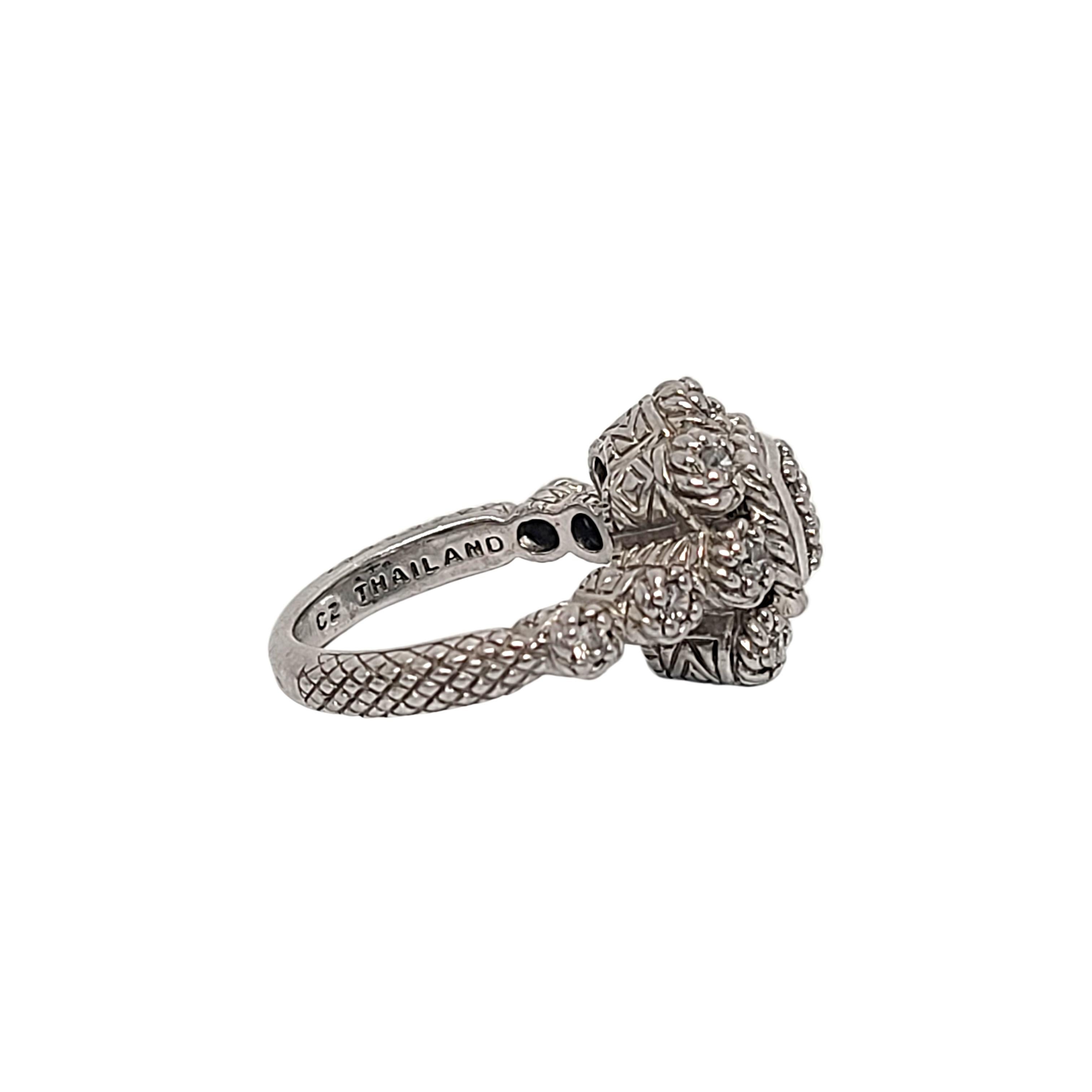 Sterling silver CZ flower cluster ring by designer Judith Ripka.

Size 7

This beautiful piece features textured design around a flower design with a cluster of CZs at its center and small CZs set in the 