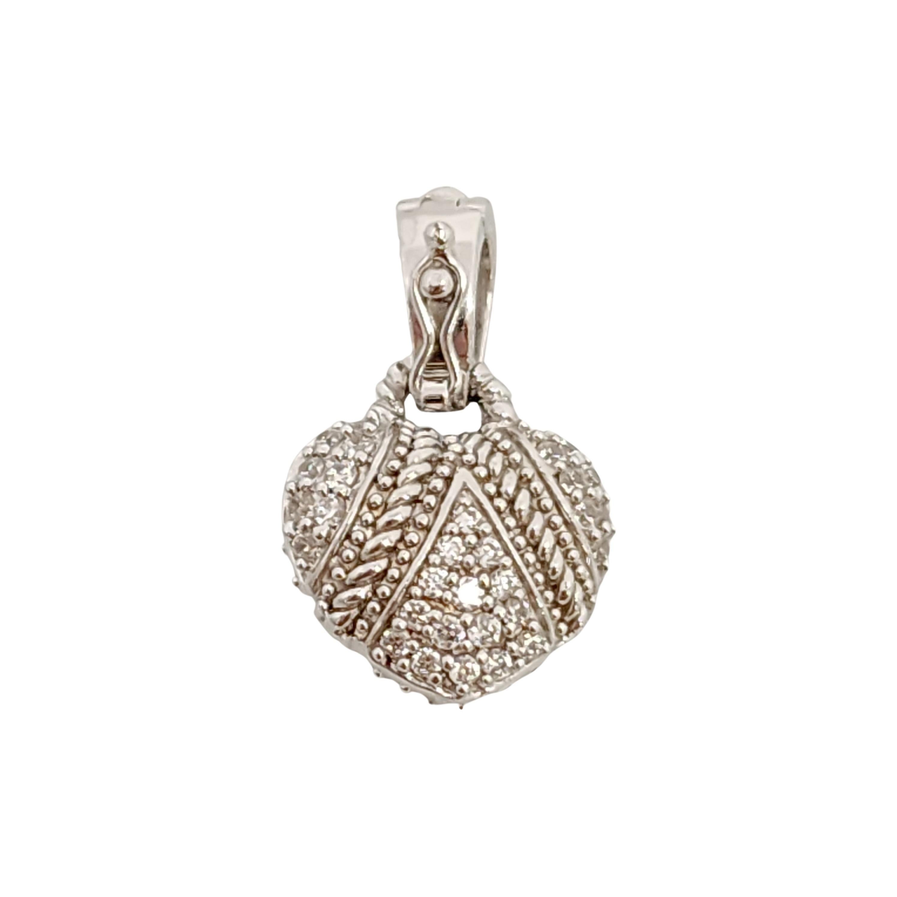 Sterling silver CZ heart pendant by Judith Ripka.

Beautiful puffy heart design pendant encrusted in CZs with bead and twist rope accents on both sides. Snap hinged bale with safety lock.

Measures approx 1 1/8